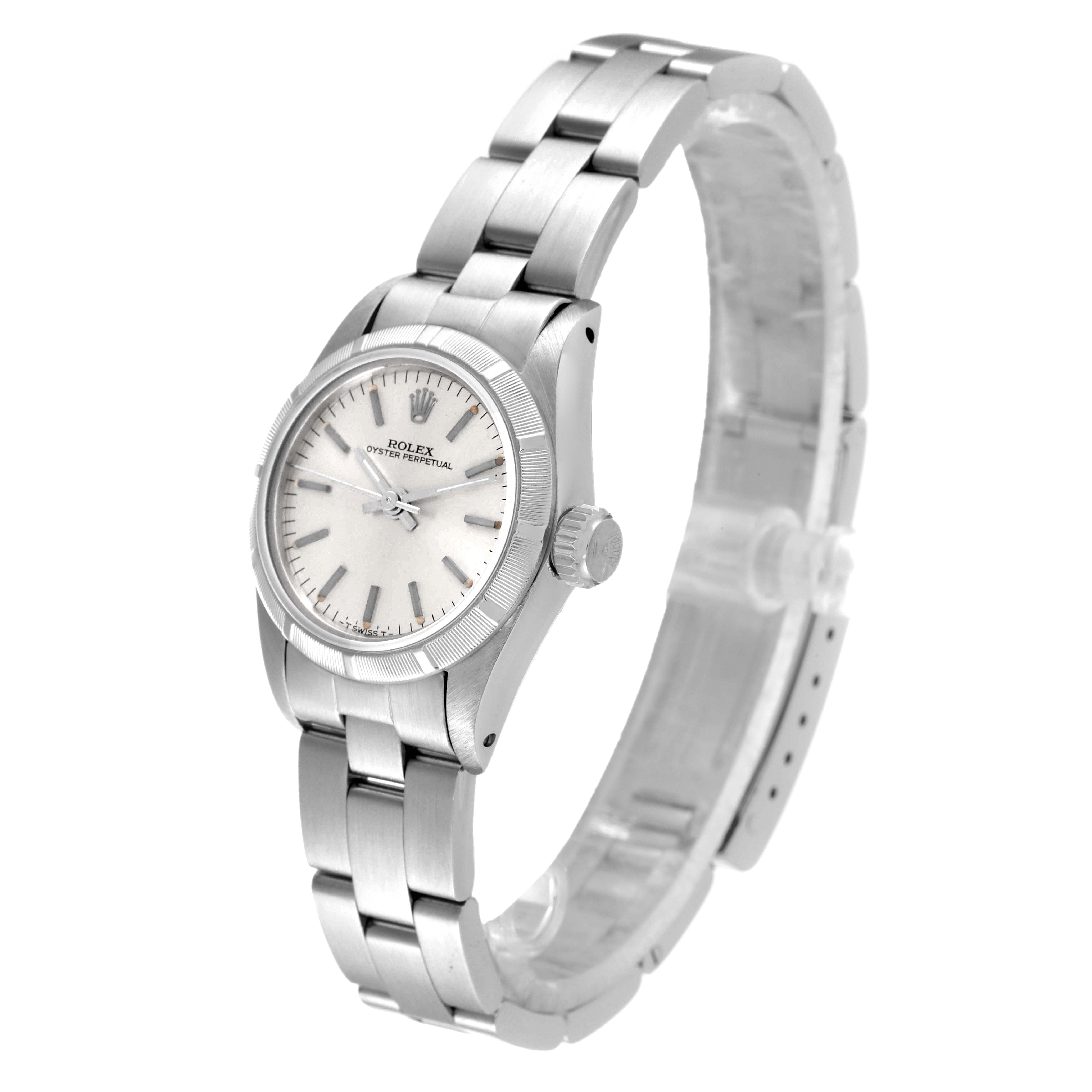 The image shows a Rolex Oyster Perpetual 67230 Women
s Stainless Steel Silver Dial 67230 Women
s Stainless Steel Silver Dial watch angled to display the face, bezel, and part of the bracelet.