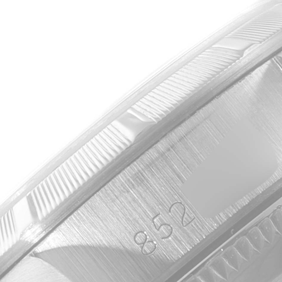 This image shows a close-up angle of the bezel and part of the side of a Rolex Oyster Perpetual 67230 Women
s Stainless Steel Silver Dial 67230 Women
s Stainless Steel Silver Dial watch.