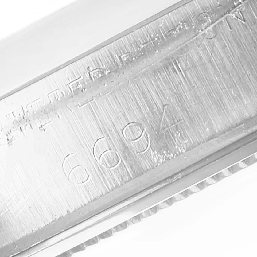 The close-up image shows the engraved serial number area of a Rolex Vintage Collection 6694 Men's Stainless Steel Black Dial 6694 Men's Stainless Steel Black Dial model watch.