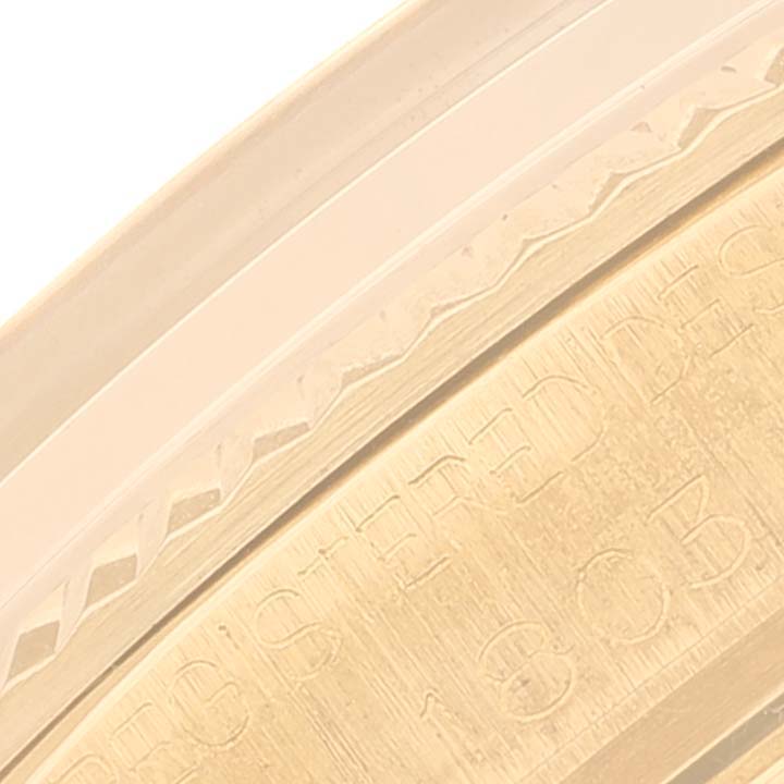 This close-up image shows a detailed view of the engraved bezel of the Rolex Vintage Collection 1803 Men's Yellow Gold Champagne Dial 1803 Men's Yellow Gold Champagne Dial watch.