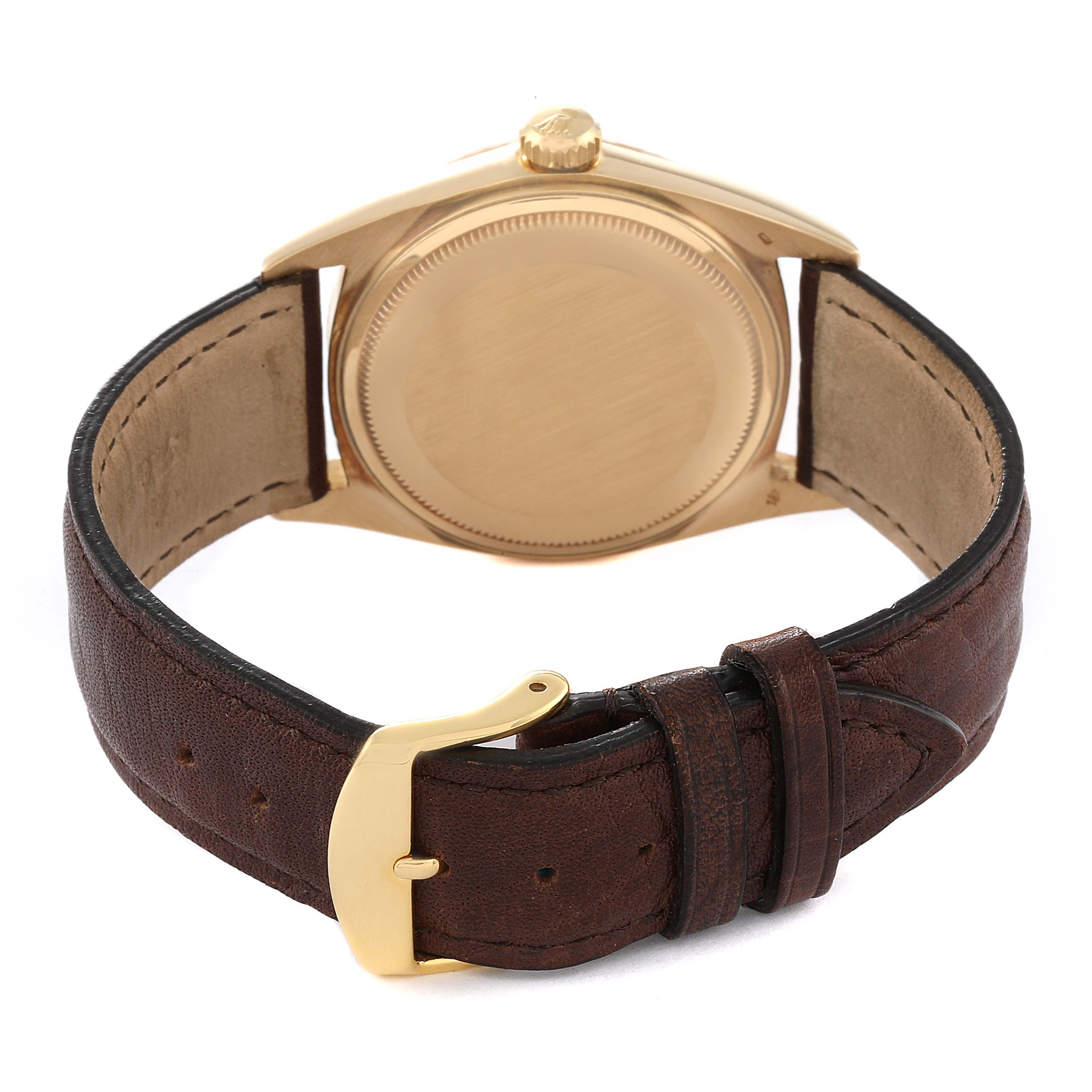 The image shows the back view of a Rolex Vintage Collection 1803 Men's Yellow Gold Champagne Dial 1803 Men's Yellow Gold Champagne Dial watch, highlighting its caseback and brown leather strap with a gold buckle.