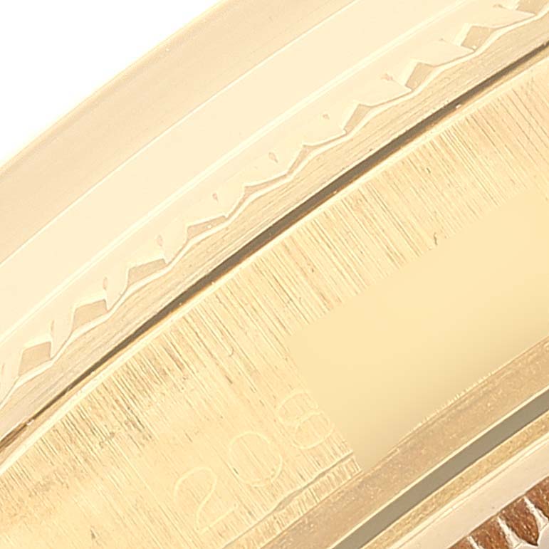 This close-up shows the engraved bezel and part of the case of the Vintage Collection model by Rolex.