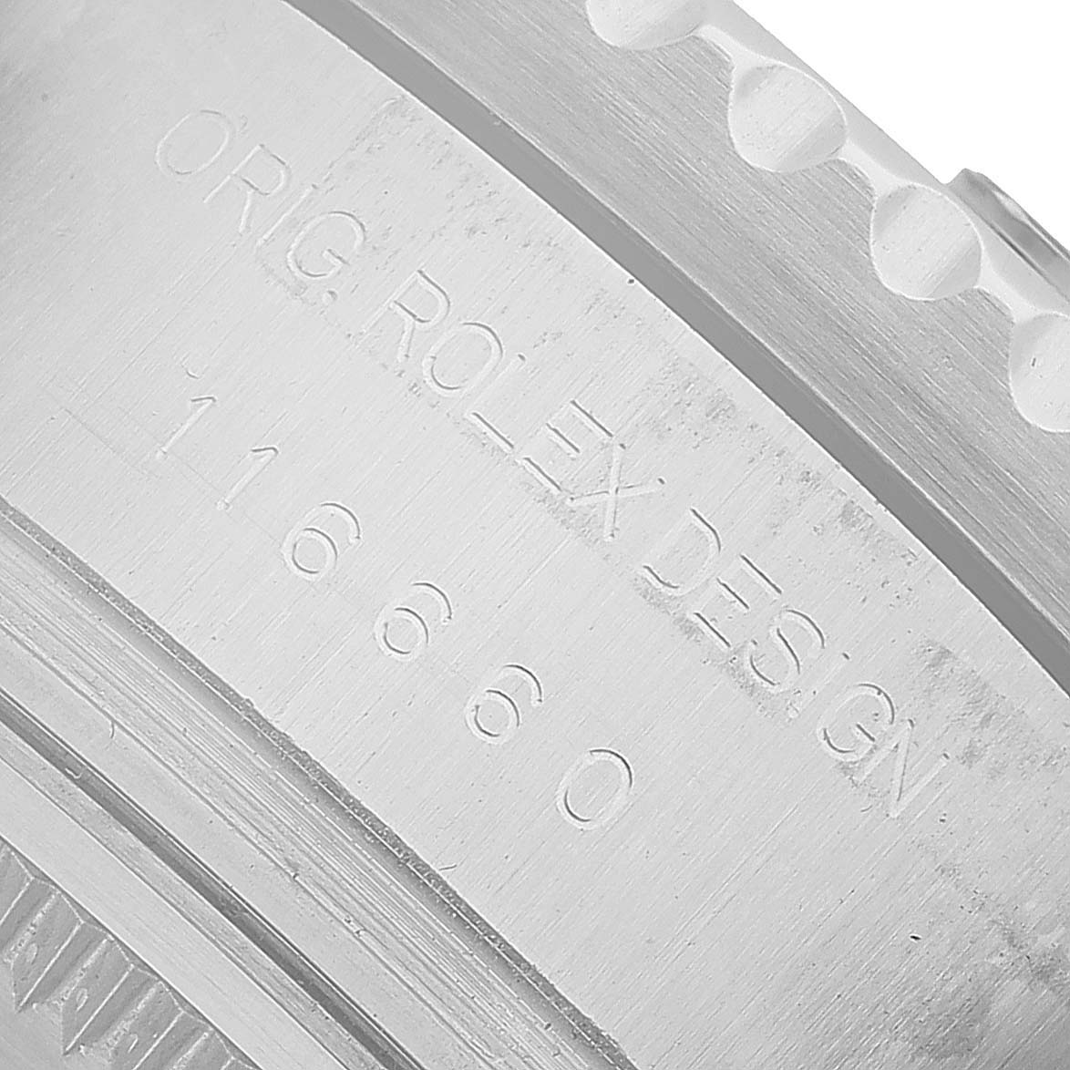 The image shows a close-up of the case side of a Rolex Sea-Dweller 116660 Men's Stainless Steel Black Dial, highlighting the engraved model number and design details.