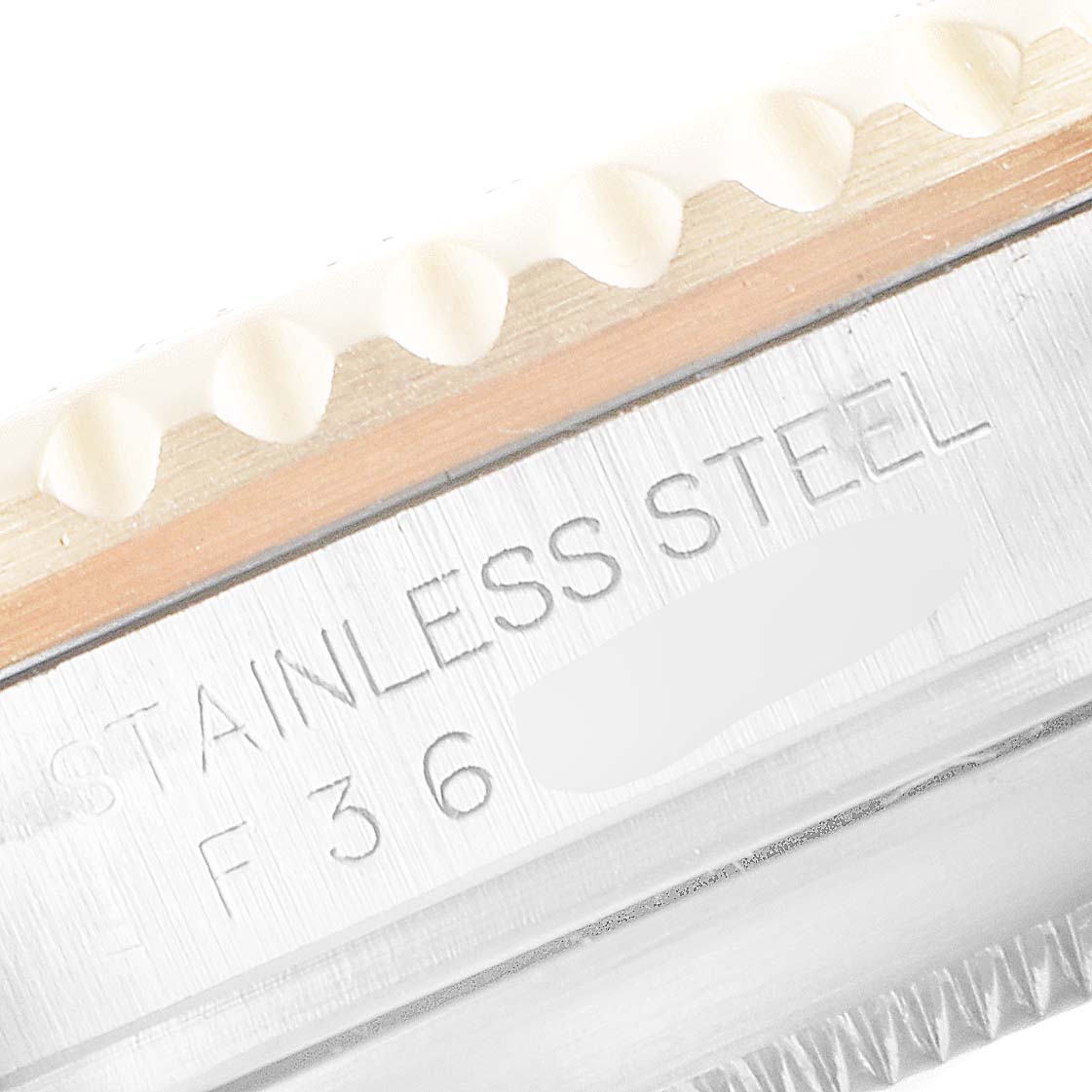 This close-up image shows the engraved text and part of the bezel on a Rolex Submariner 16613 Men's Steel and Gold (two tone) Black Dial 16613 Men's Steel and Gold (two tone) Black Dial watch.