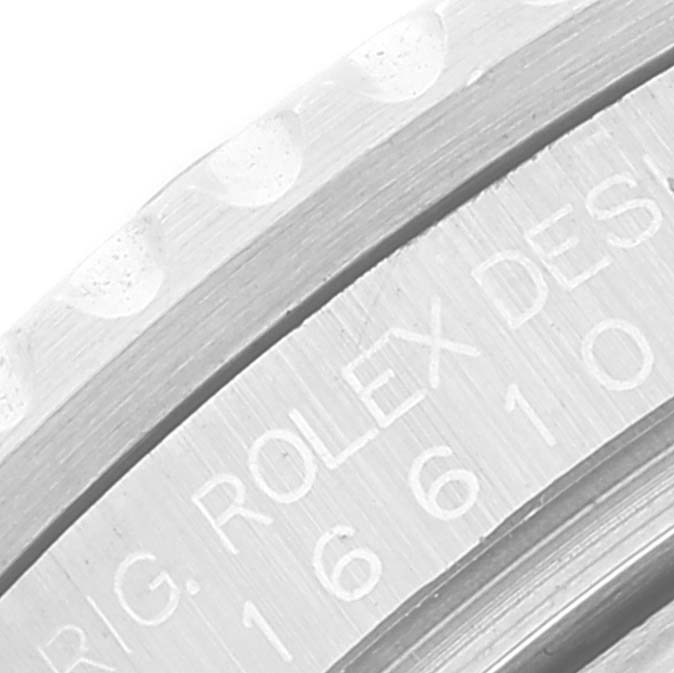 The image shows a close-up of the engraved inner bezel and part of the outer bezel of a Rolex Submariner 16610 Men's Stainless Steel Black Dial 16610 Men's Stainless Steel Black Dial watch.