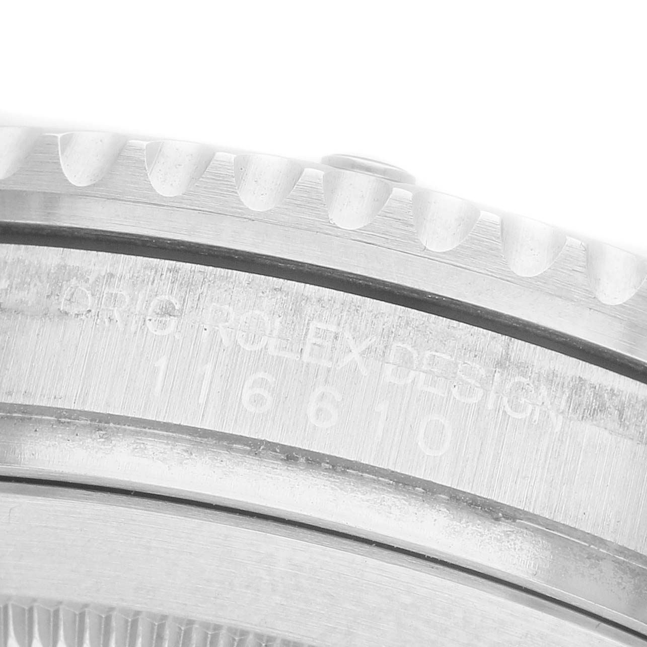 This image shows a close-up of the side of a Rolex Submariner 116610 Men's Stainless Steel Black Dial, focusing on the engraved model number on the case.
