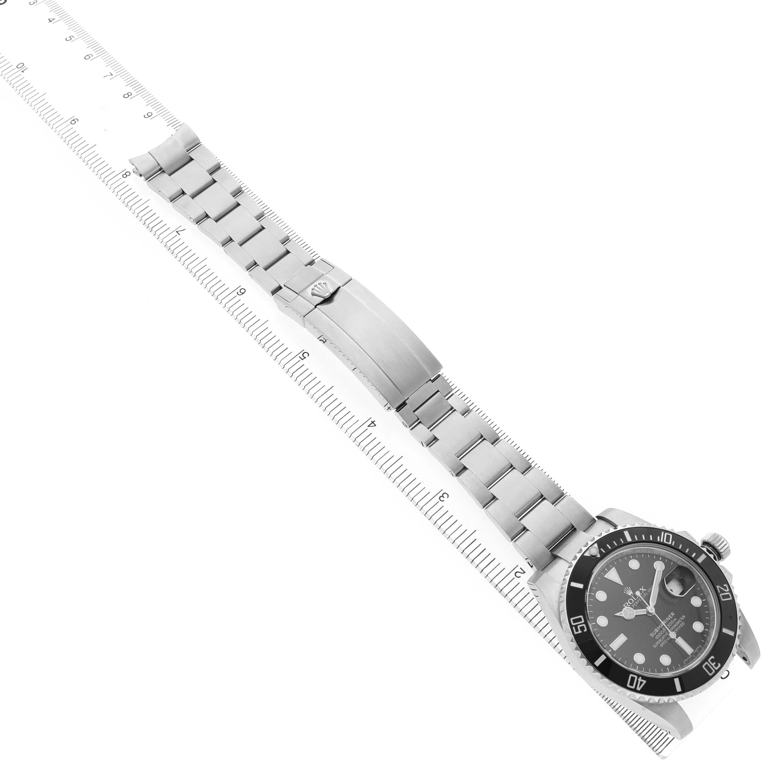 The Rolex Submariner 116610 Men's Stainless Steel Black Dial watch is shown from a high angle, displaying the entire bracelet, clasp, bezel, and face.