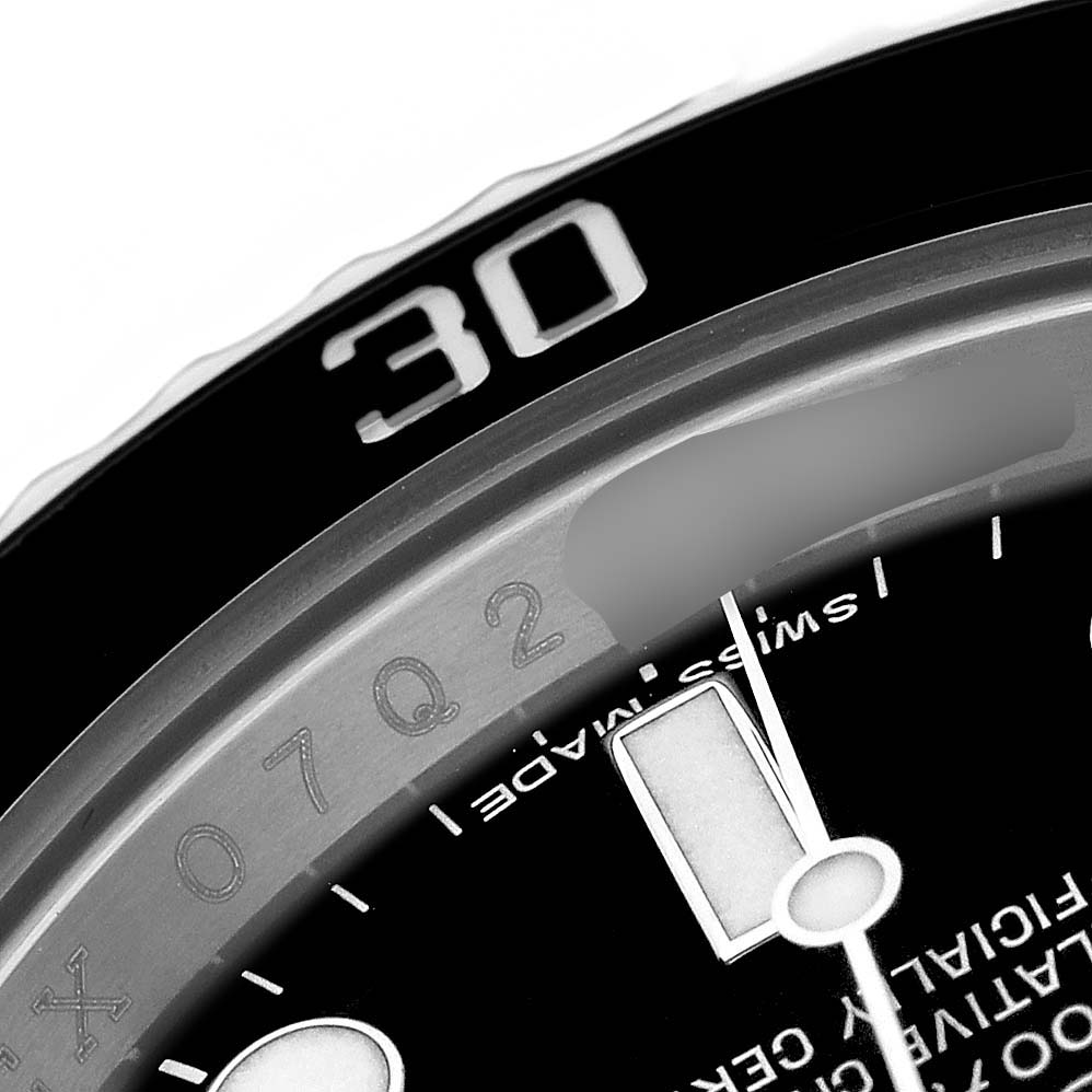 The image shows the bezel and part of the dial with a minute hand of a Rolex Submariner 116610 Men's Stainless Steel Black Dial watch, viewed up close.