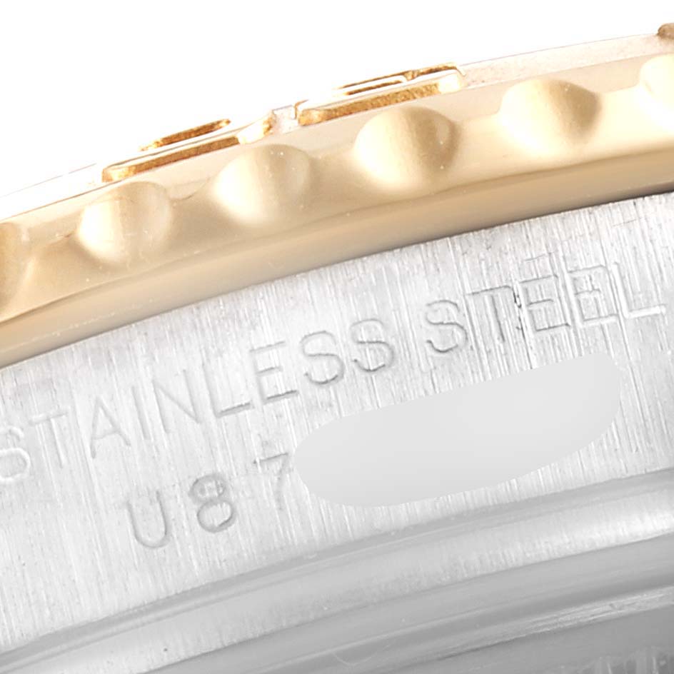 The image shows a close-up of the bezel and case sides, illustrating the texture and engraving details of the Yacht-Master model by Rolex.