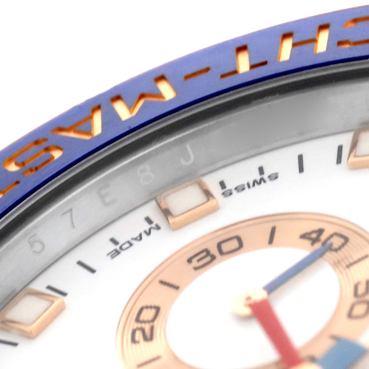 The image shows a close-up of the bezel and part of the dial of a Rolex Yacht-Master 116681 Men
s Steel and Gold (two tone) White Dial 116681 Men
s Steel and Gold (two tone) White Dial watch.