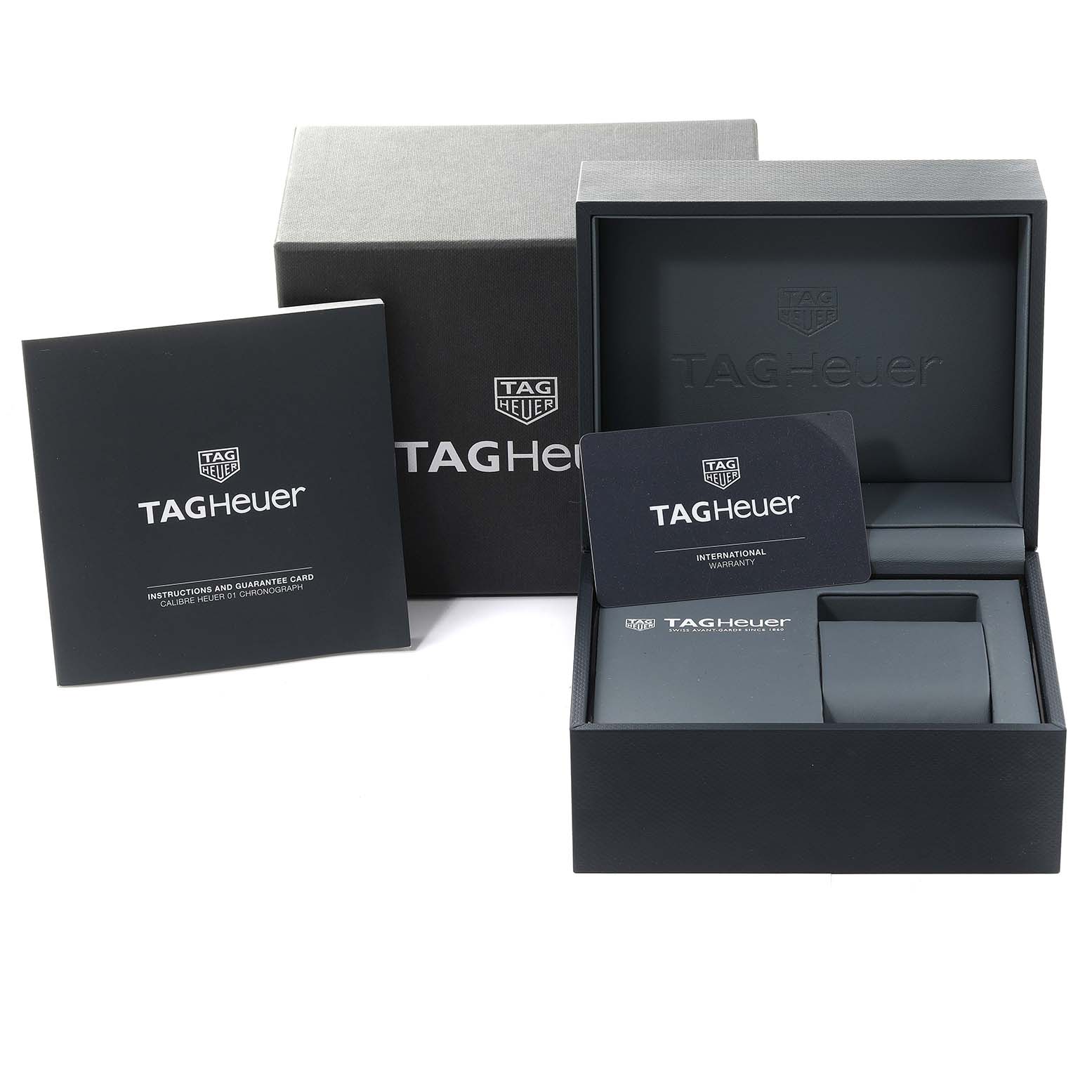 The image shows the box, warranty card, and instruction manual for a Tag Heuer Carrera CAR201T Men's Stainless Steel Blue Dial CAR201T Men's Stainless Steel Blue Dial watch.