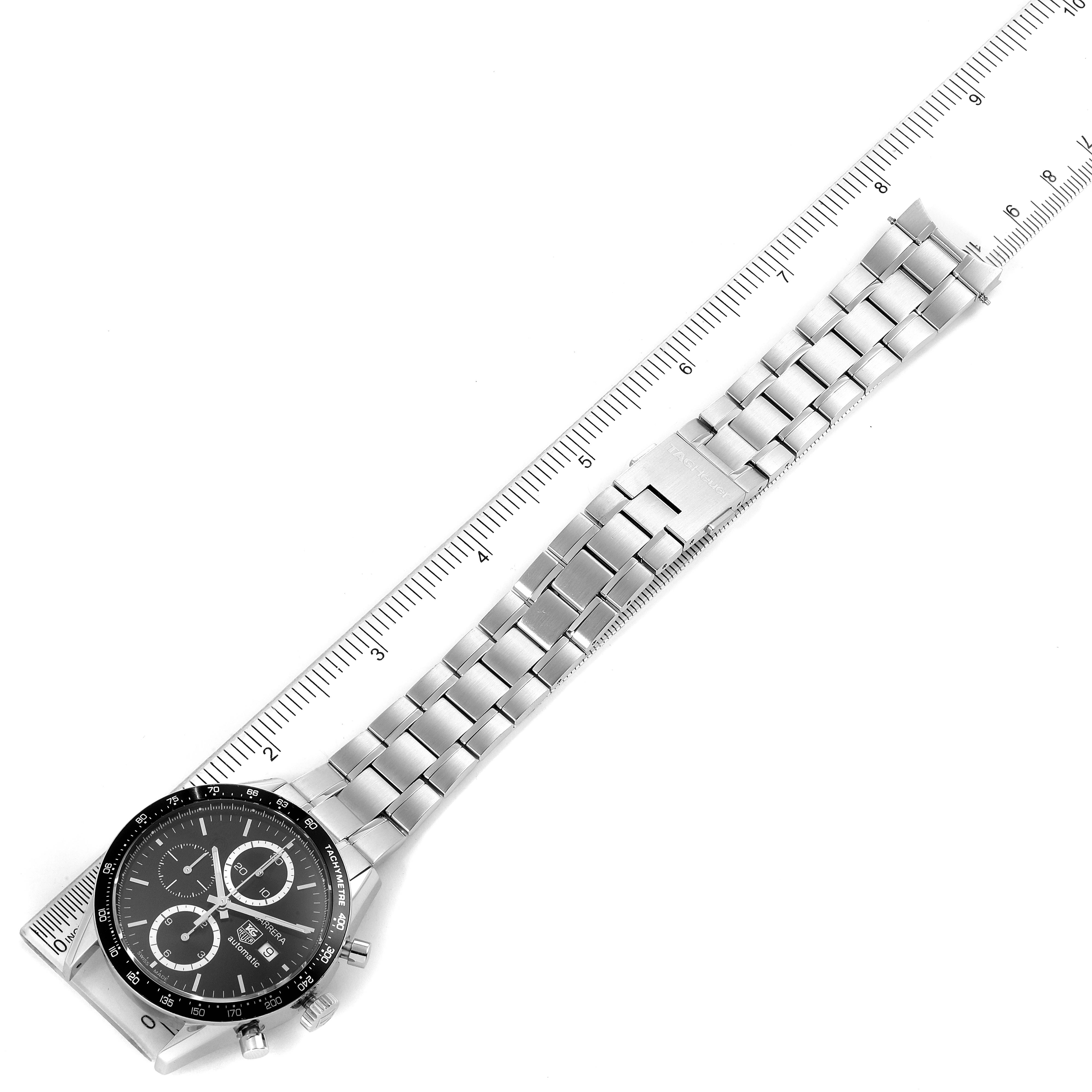 The image shows a Tag Heuer Carrera CV2010 Men's Stainless Steel Black Dial CV2010 Men's Stainless Steel Black Dial watch with a stainless steel bracelet and a ruler for measuring length.