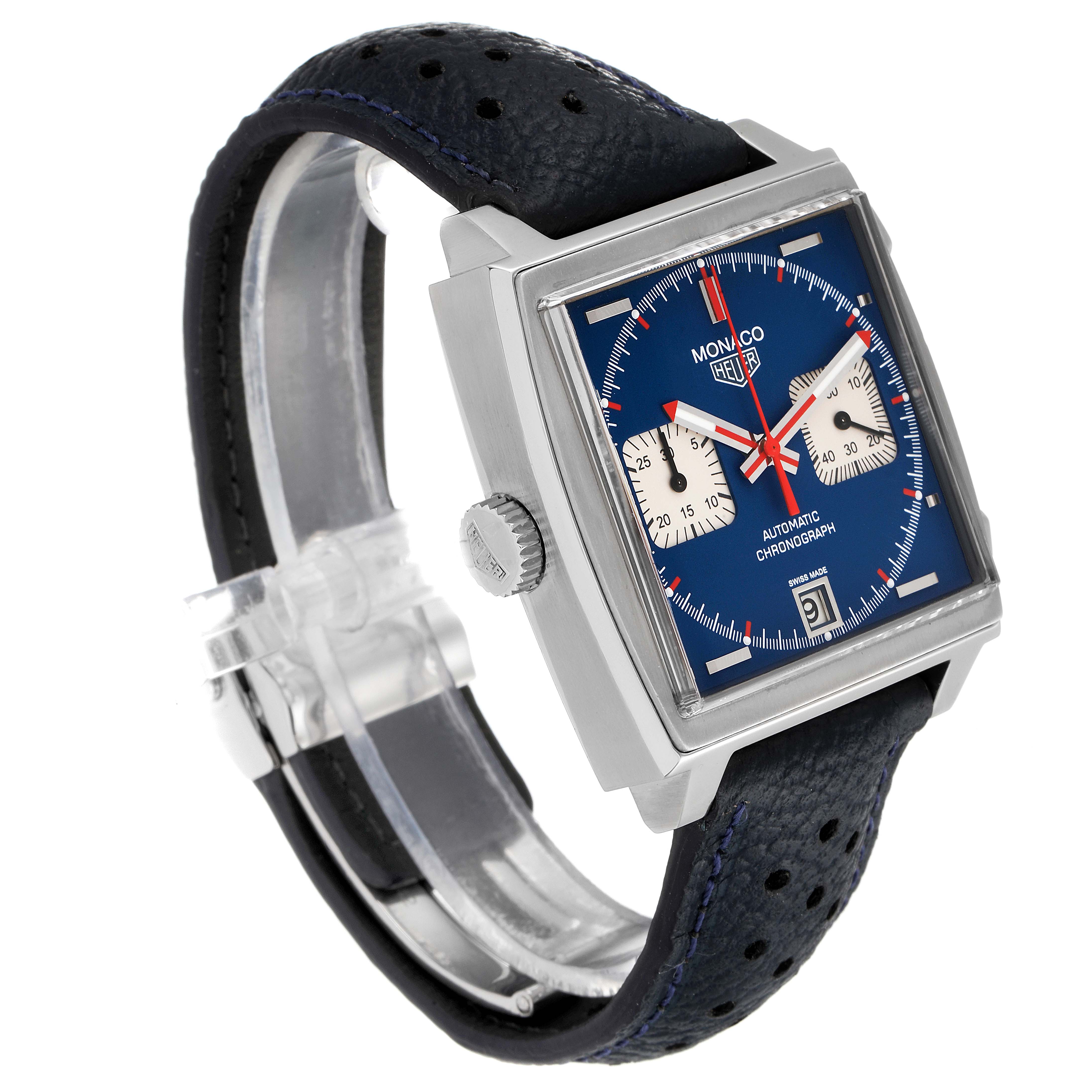 The image shows a Tag Heuer Monaco watch from an angled side view, highlighting its square case, blue dial, and leather strap.