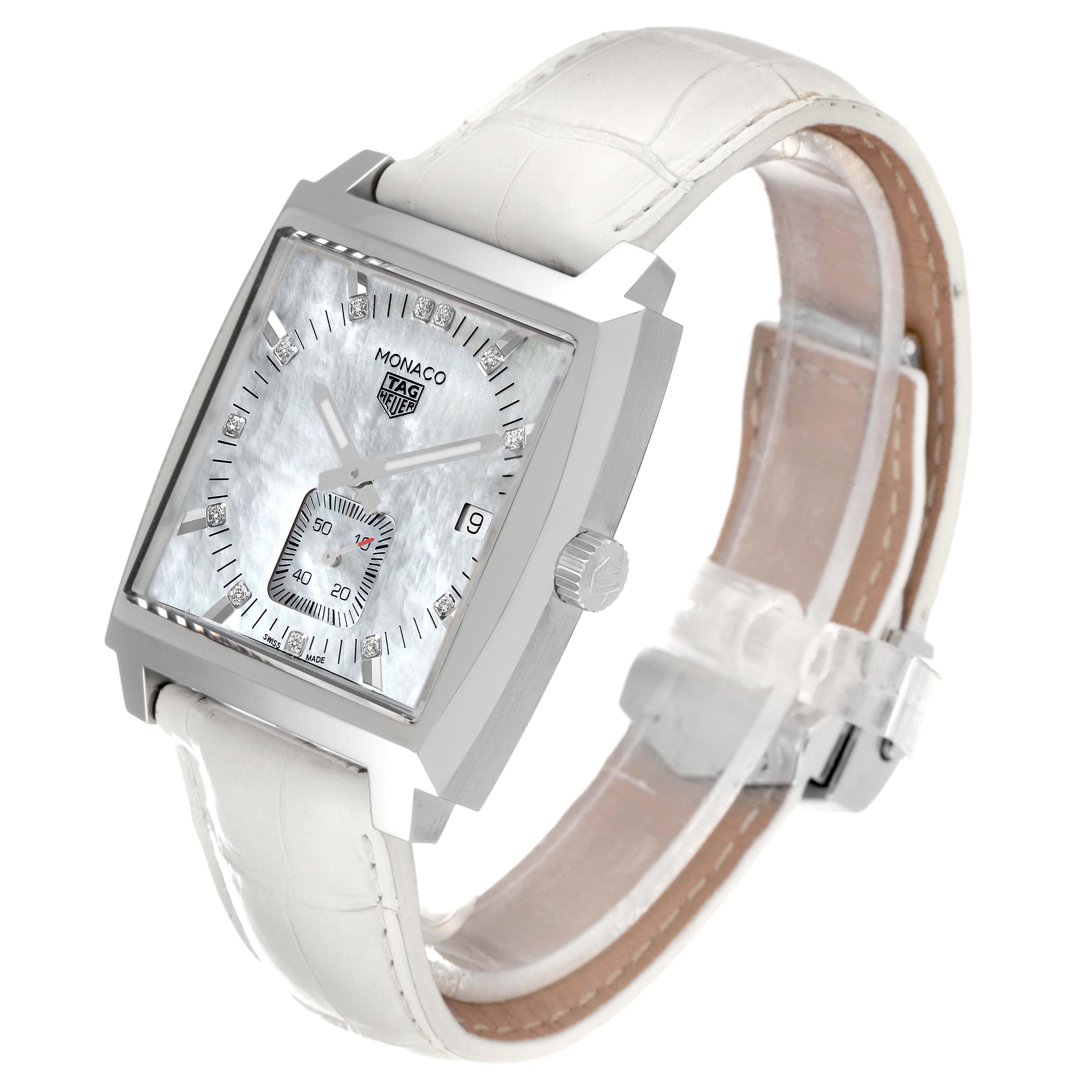 The image shows a close-up angle of the Monaco model by Tag Heuer, displaying its face, dial, and white leather strap.
