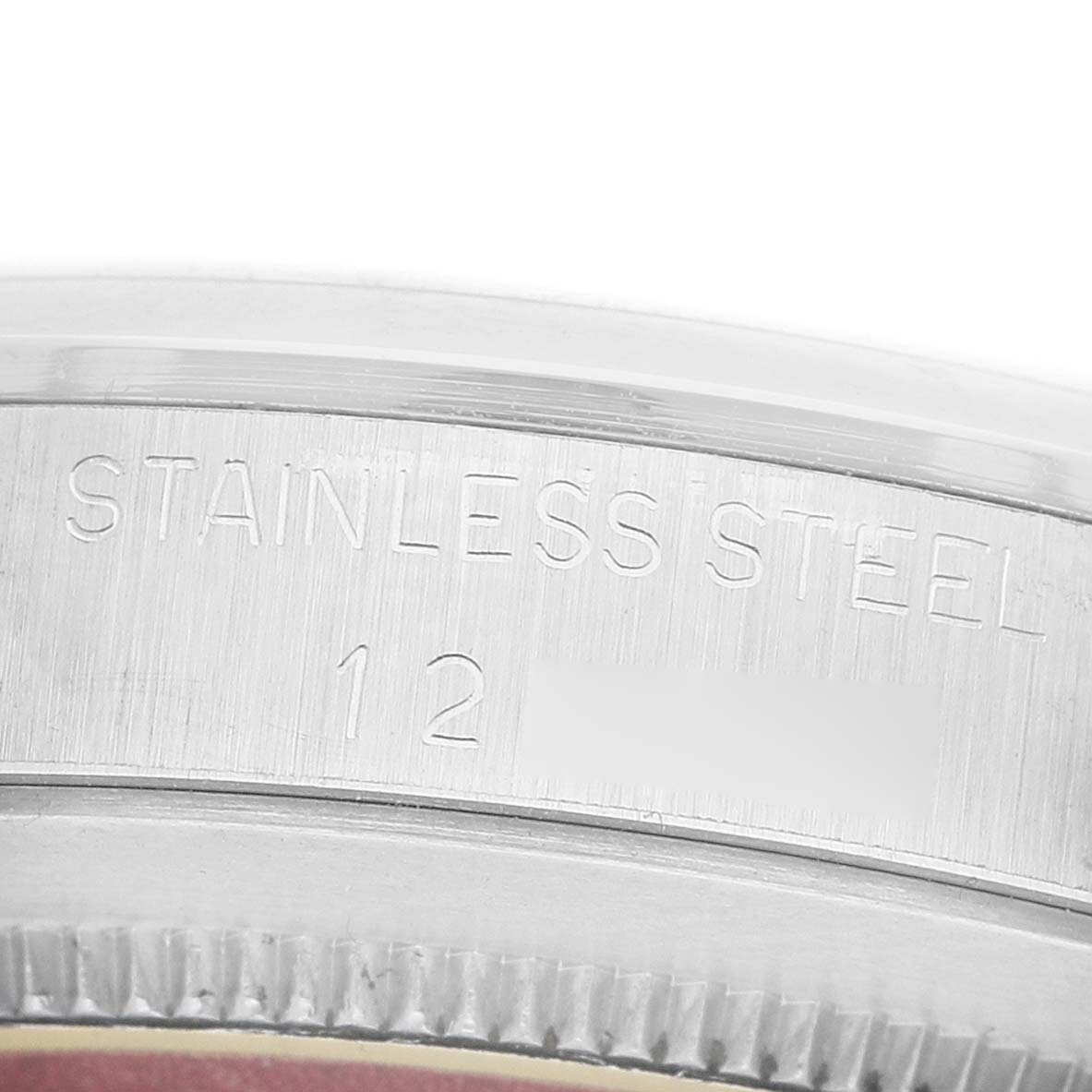 The image shows the edge and engravings of the stainless steel case back of a Tudor Prince 74000 Men's Stainless Steel Silver Dial watch.