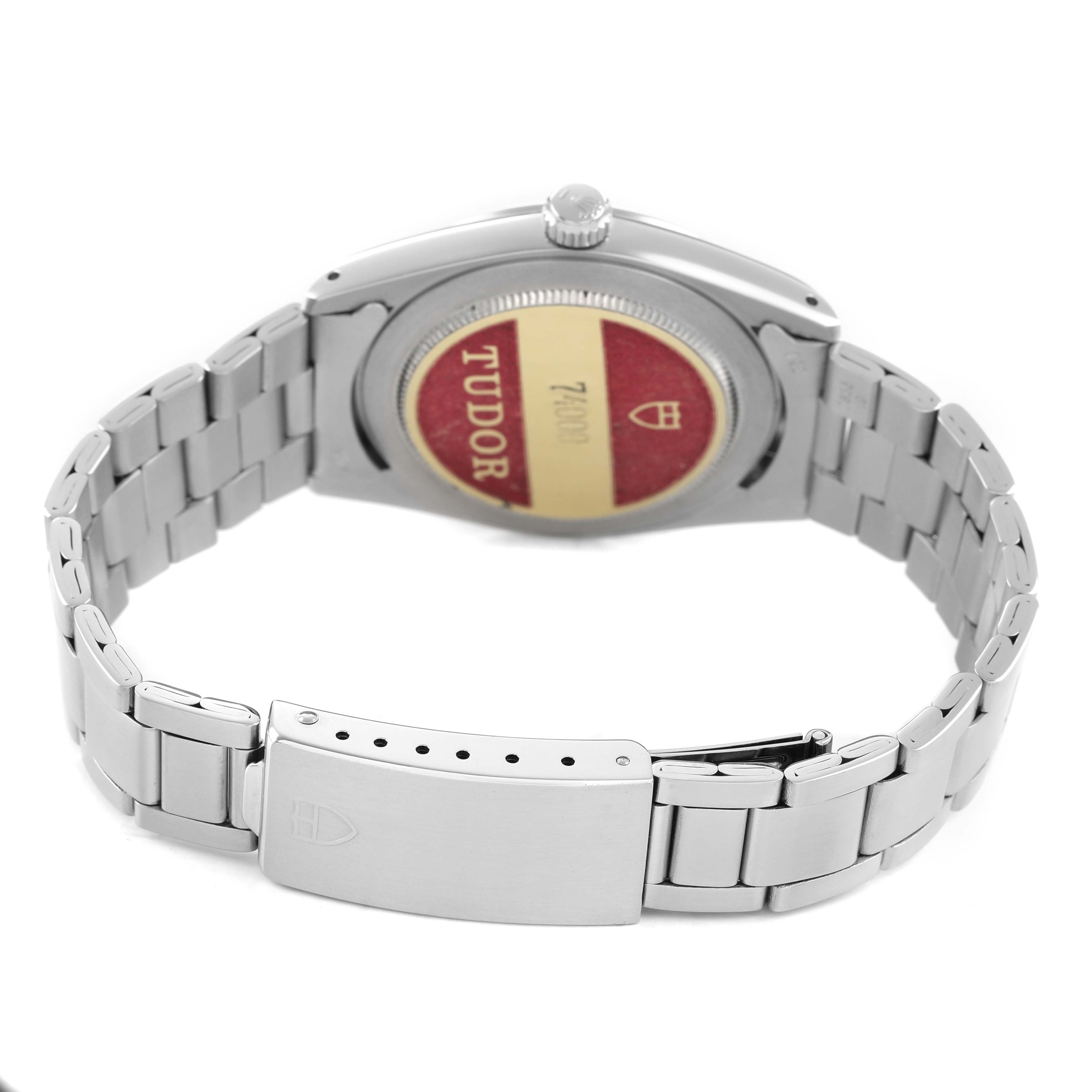 The image shows the back and bracelet of a Tudor Prince 74000 Men's Stainless Steel Silver Dial watch, highlighting the clasp and case back with Tudor branding.