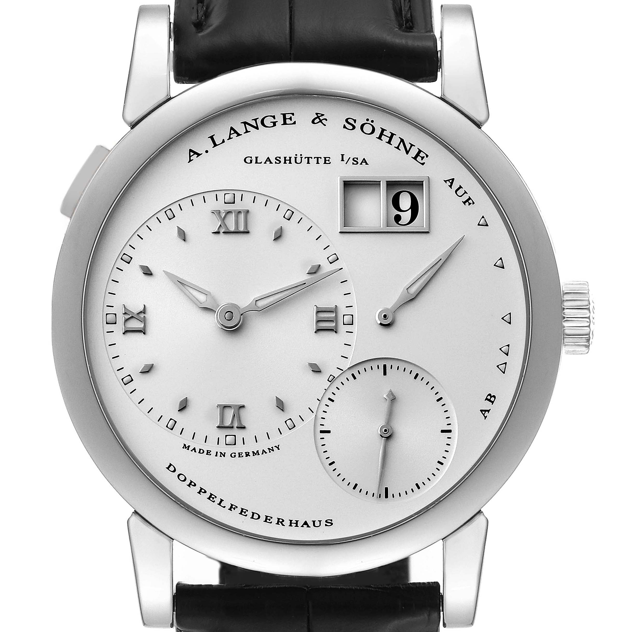 The image shows a frontal view of the Lange 1 model by A. Lange & Söhne, detailing its face, dials, and black leather strap.