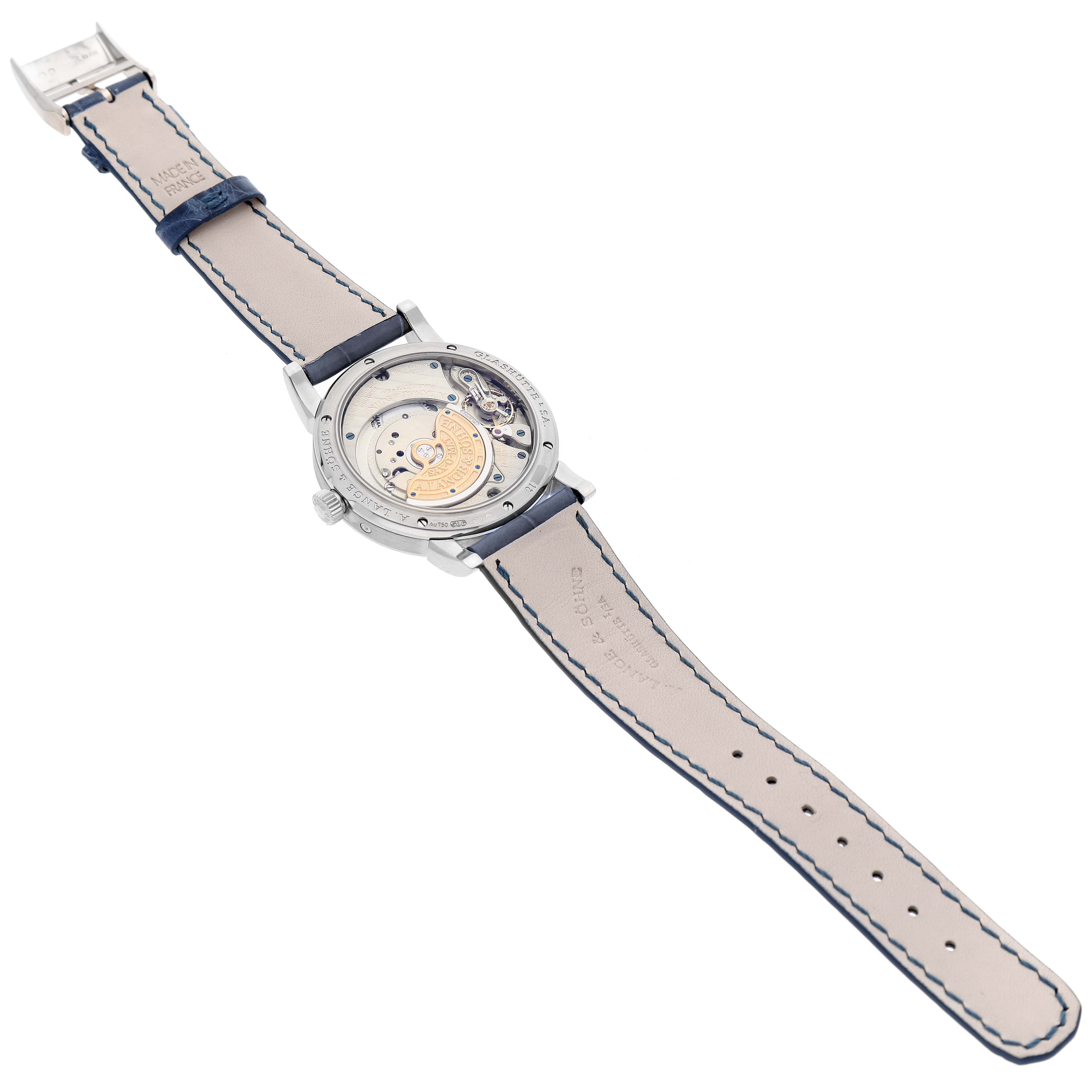 The image shows the back view of the A. Lange 
Sohne Saxonia 330.026 Men
s White Gold Silver Dial model, highlighting its intricate movement and leather strap.