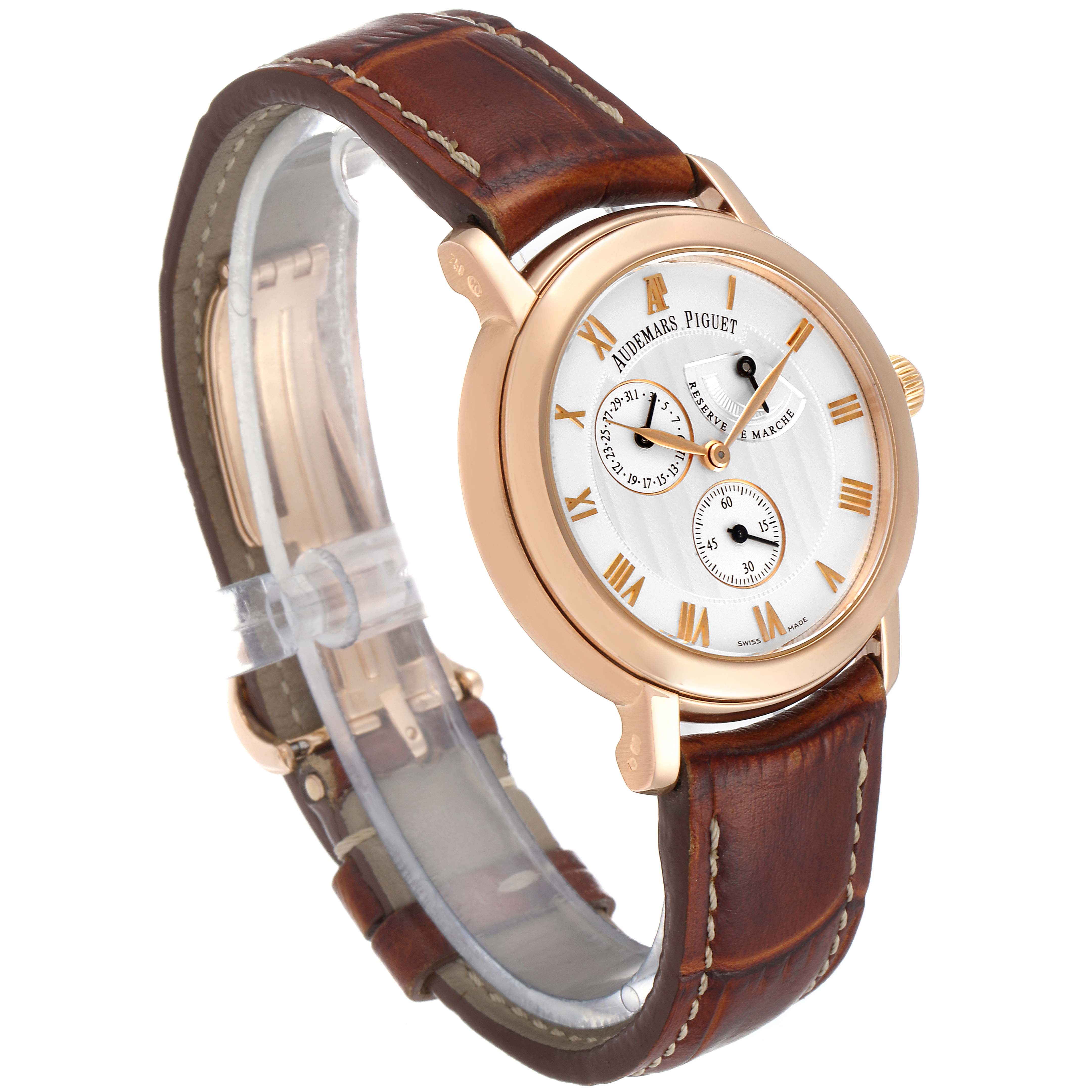 The image shows the Audemars Piguet Jules 25955OR.OO.D002CR.01 Men's Rose Gold Silver Dial 25955OR.OO.D002CR.01 Men's Rose Gold Silver Dial watch at a three-quarter angle, displaying its face, bezel, crown, and leather strap.