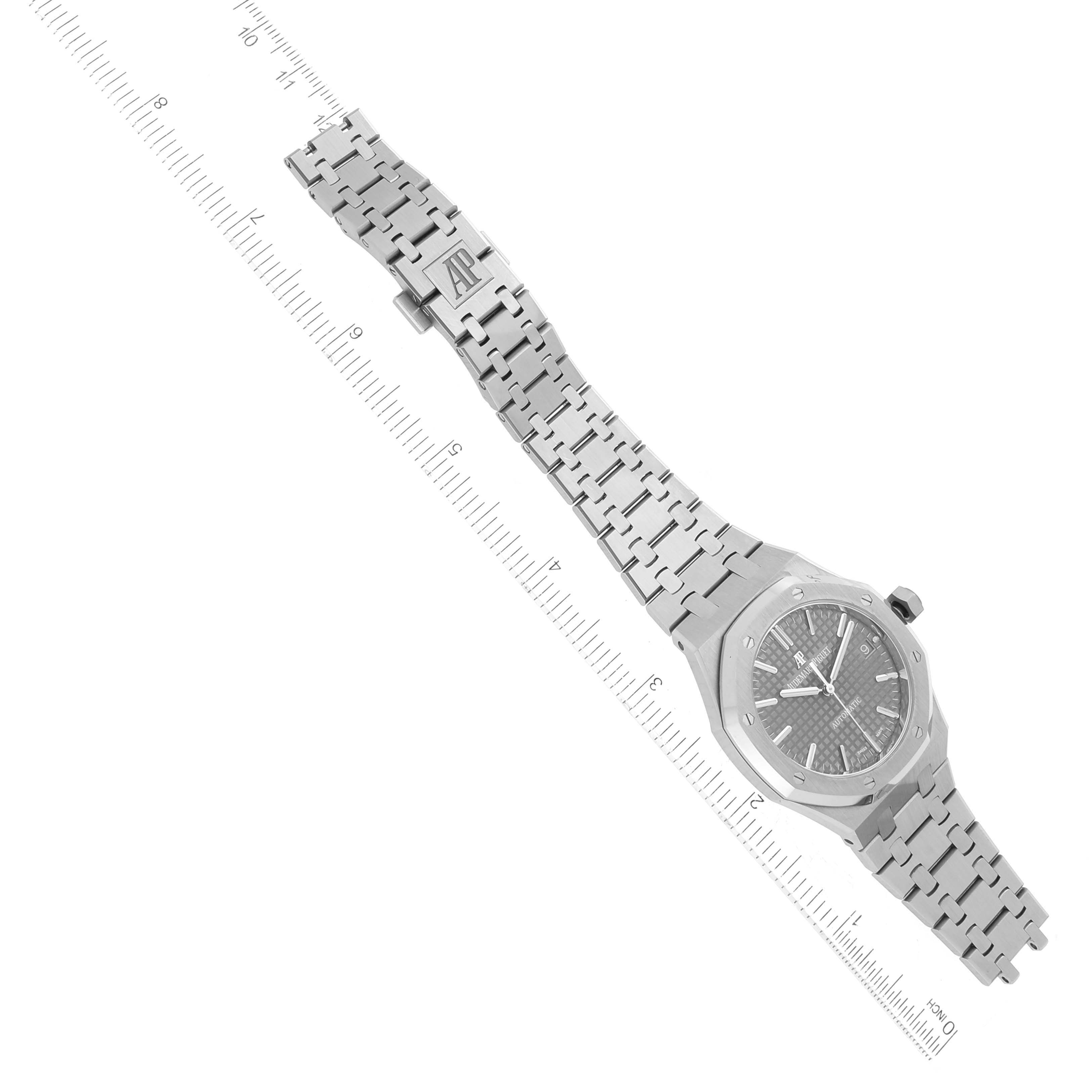 The image shows a top view of an Audemars Piguet Royal Oak 15450ST Men's Stainless Steel Grey Dial 15450ST Men's Stainless Steel Grey Dial watch with its bracelet fully extended and parallel to a ruler.