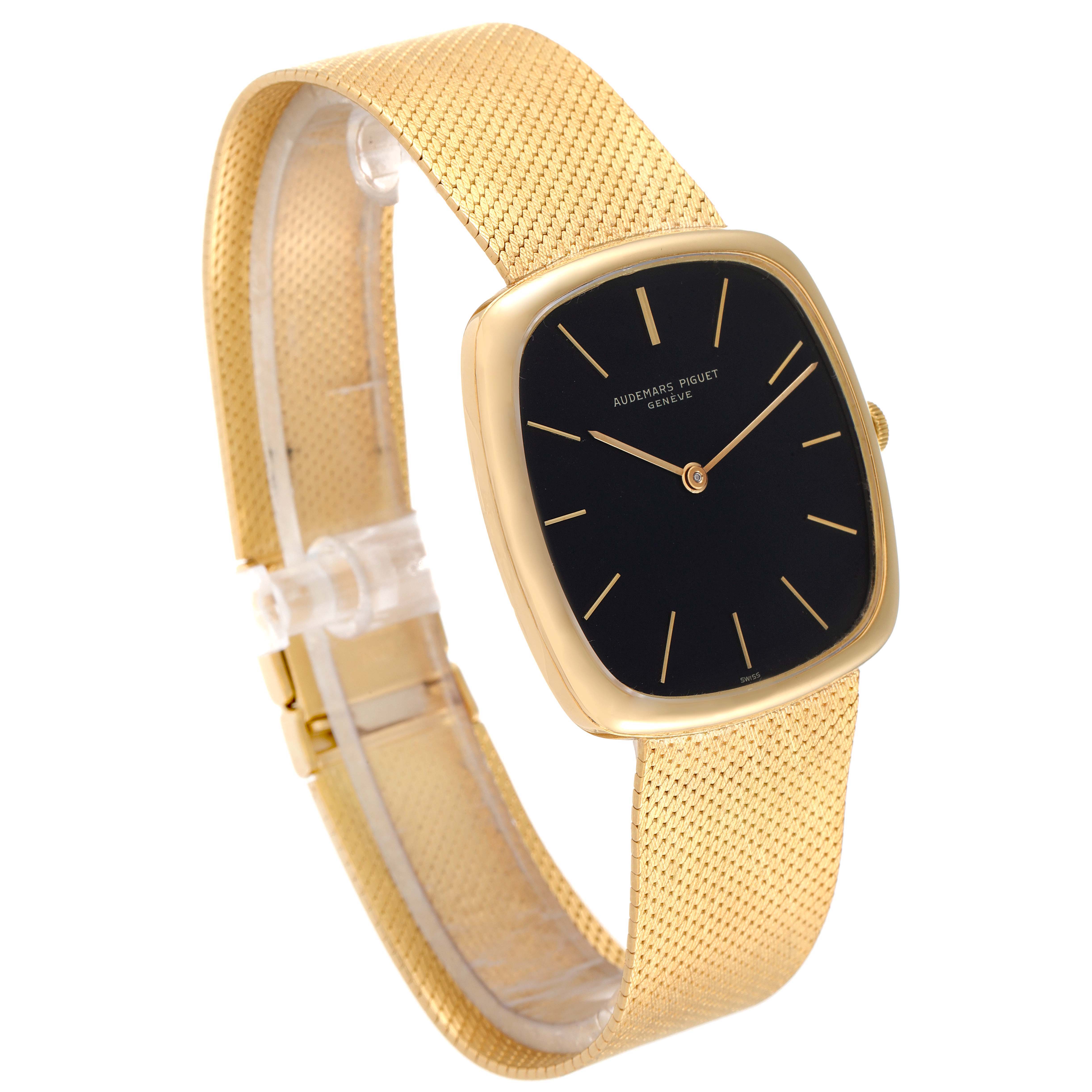 This image shows a side angle view of a Vintage Audemars Piguet watch featuring a gold mesh band and a black dial.