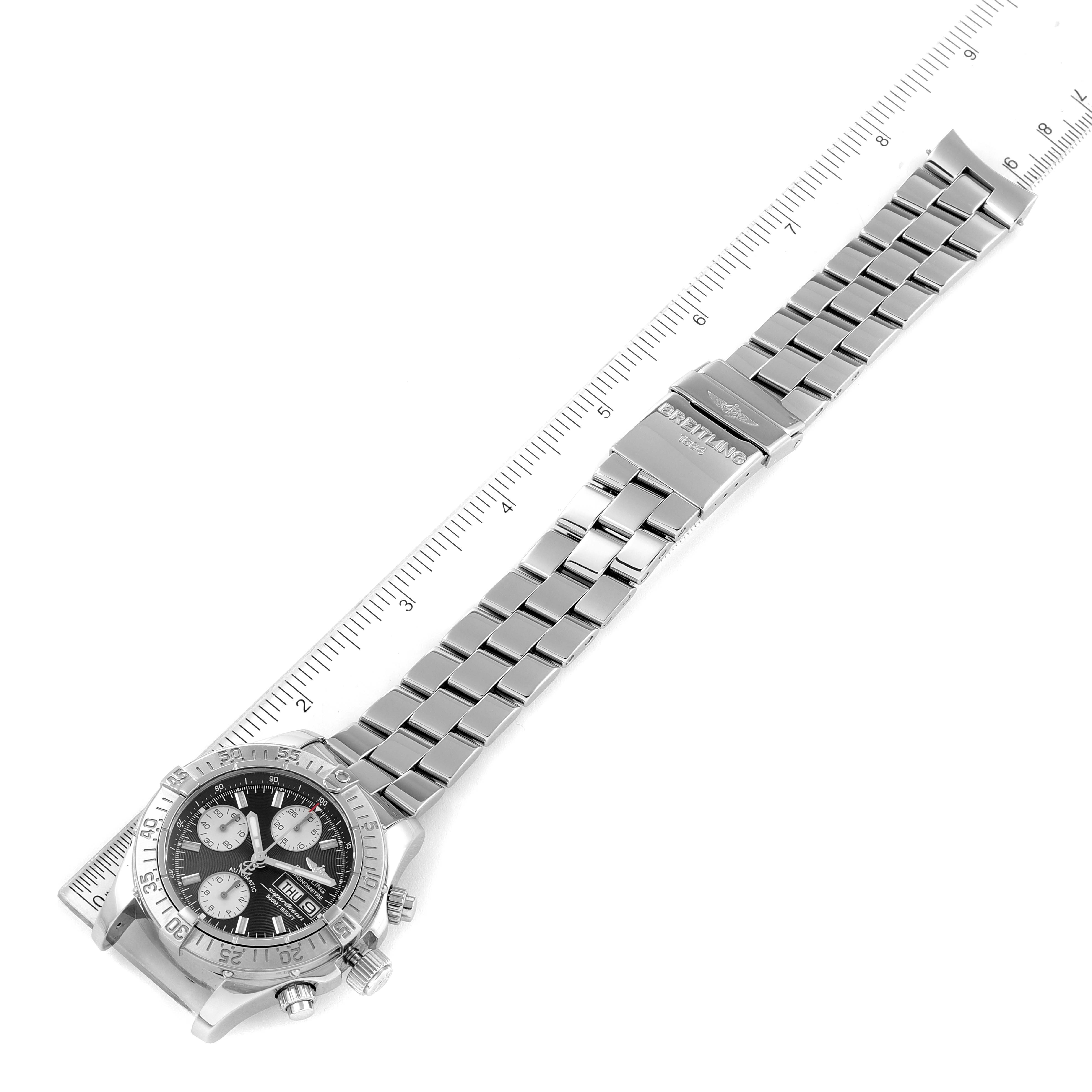 The image shows a Breitling Superocean A13340 Men's Stainless Steel Black Dial A13340 Men's Stainless Steel Black Dial watch with its dial and full metal bracelet extended measured against a ruler.
