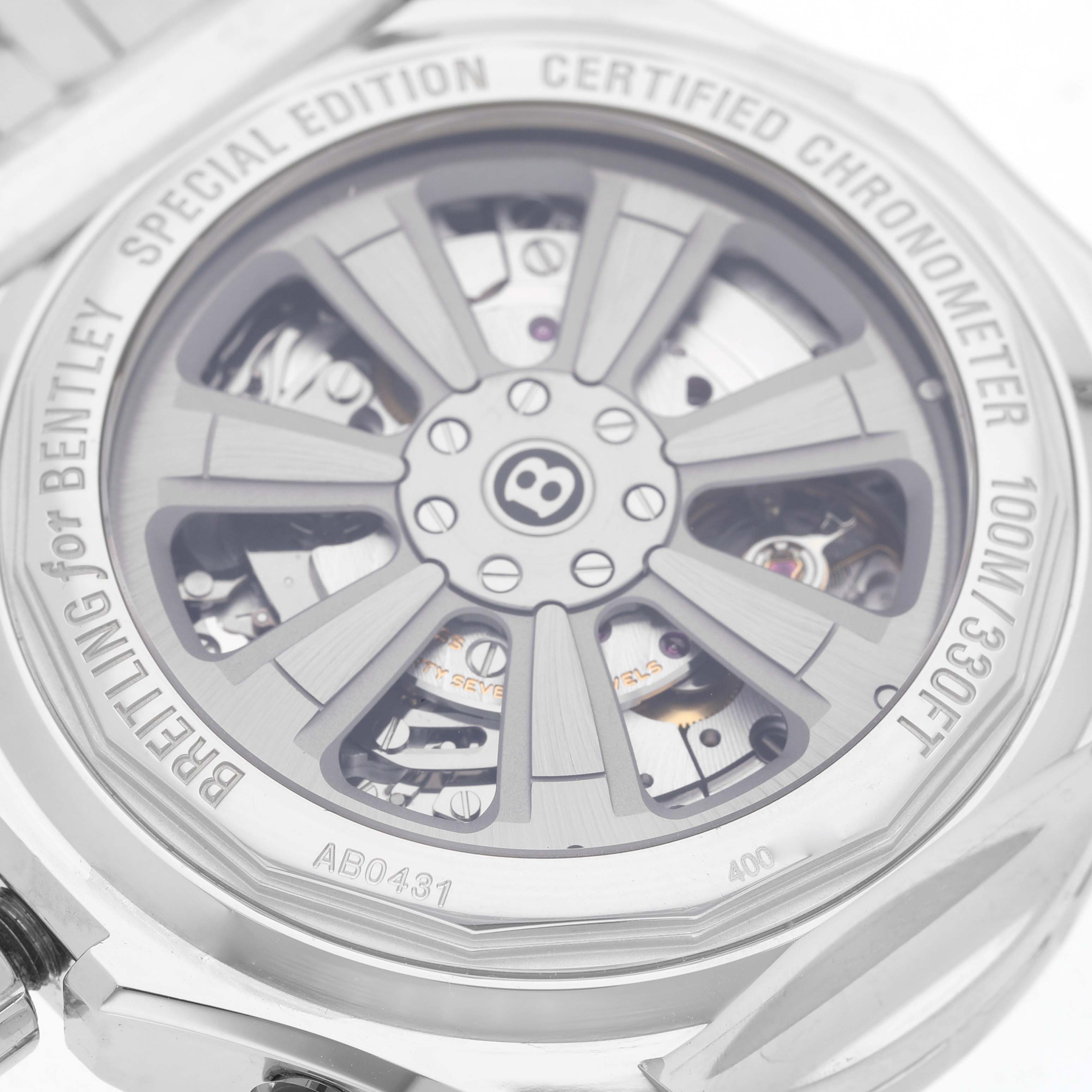 The image shows the back of a Breitling Bentley AB0431 Men's Stainless Steel Silver Dial watch, highlighting its rotor design and inscriptions around the case edge.