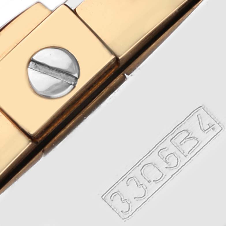 This close-up shows part of the bracelet clasp with a screw detail and engraving on a Breitling Chronomat C156A19PAC Men
s Steel and Gold (two tone) Silver Dial C156A19PAC Men
s Steel and Gold (two tone) Silver Dial watch.