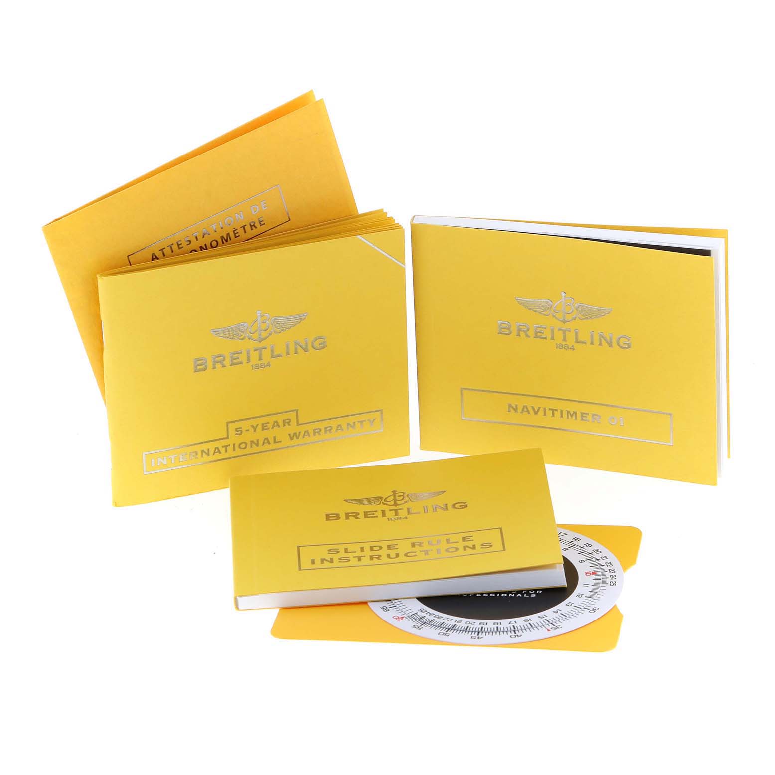 This image shows the documentation and accessories for the Breitling Navitimer AB0120 Men's Stainless Steel Black Dial AB0120 Men's Stainless Steel Black Dial, including warranty, instructions, and a slide rule.