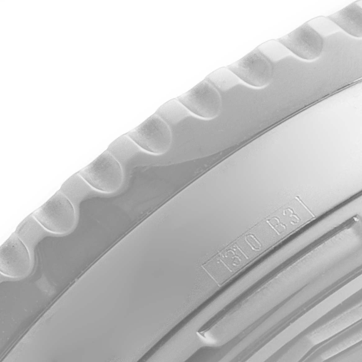 This image shows a close-up of the bezel edge and part of the case back of a Breitling Navitimer A23322 Men's Stainless Steel Black Dial A23322 Men's Stainless Steel Black Dial watch.