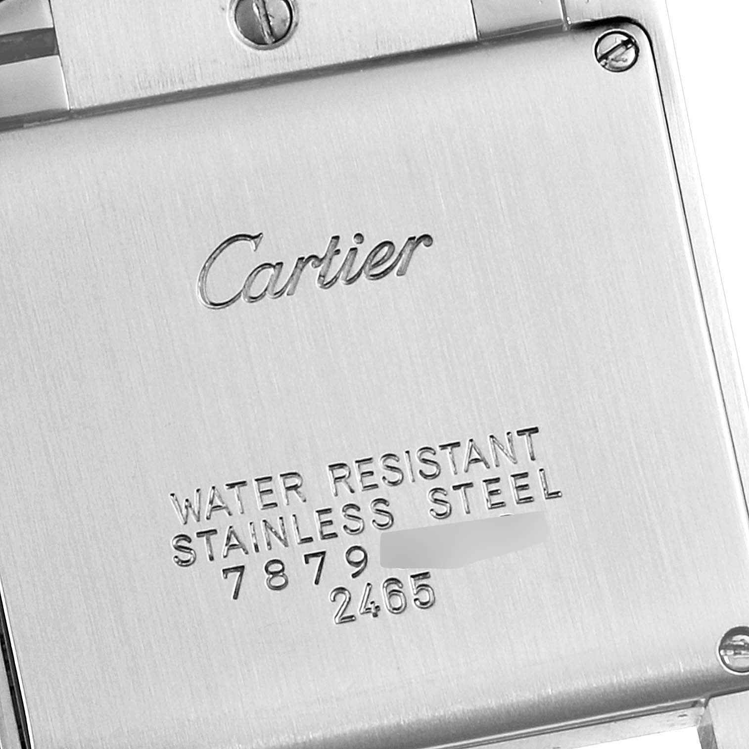 The image shows the case back of a Cartier Tank Française watch, featuring its engravings and screws.