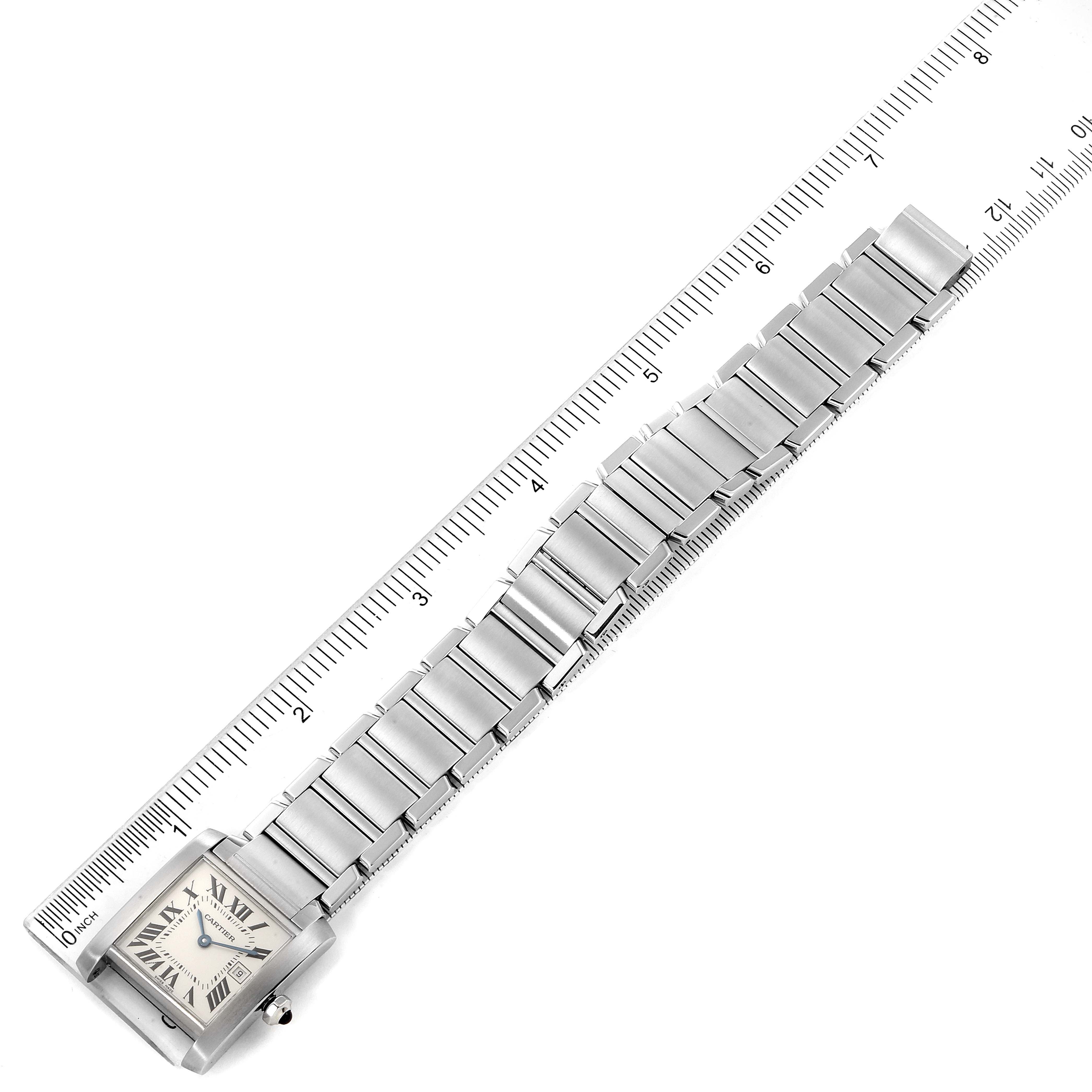 The image shows a top view of a Cartier Tank Francaise W51011Q3 Women's Stainless Steel Silver Dial W51011Q3 Women's Stainless Steel Silver Dial watch with a ruler for scale, displaying the watch face and metal bracelet.
