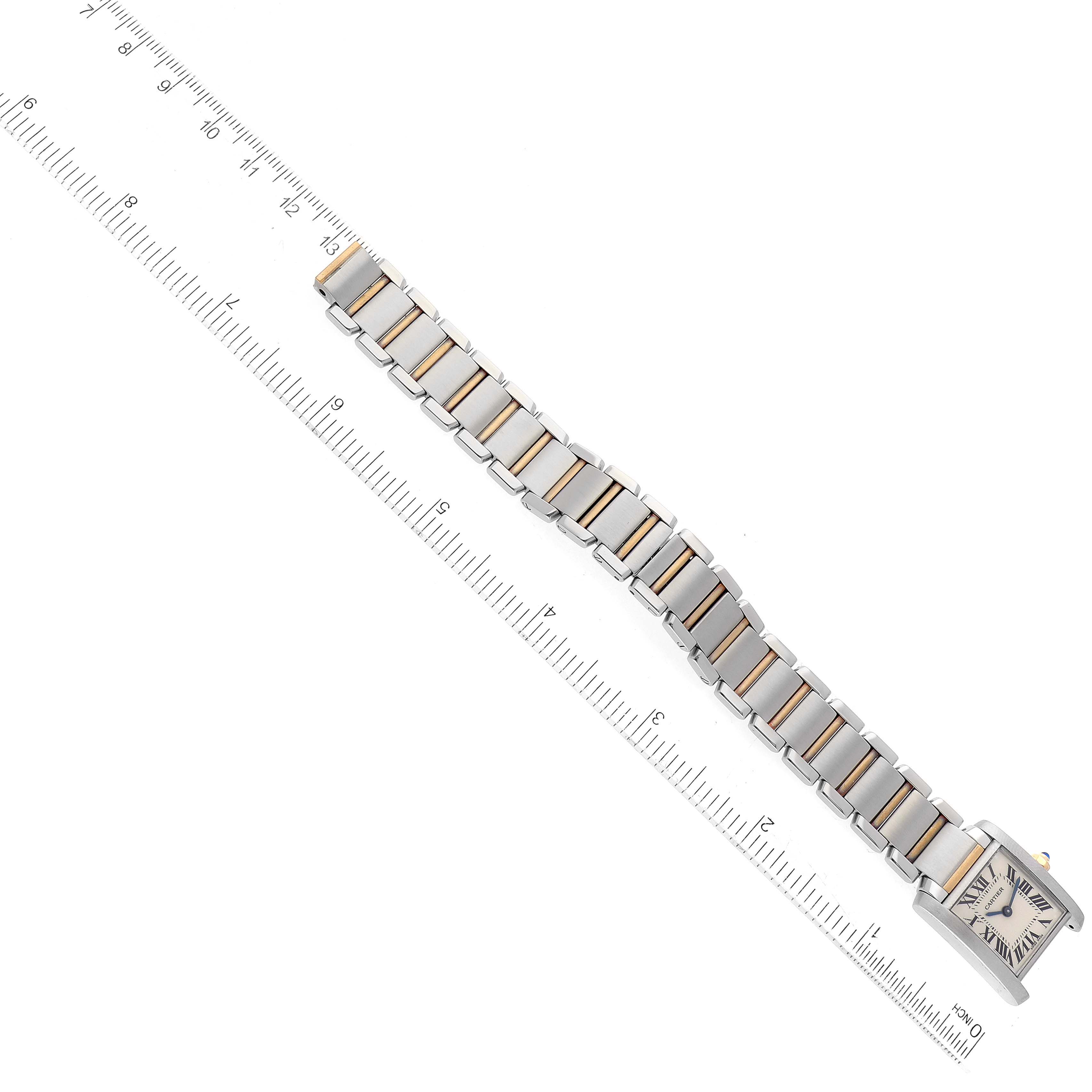 The image shows the Tank Francaise by Cartier from a top-down angle, displaying the entire bracelet alongside a ruler for scale.