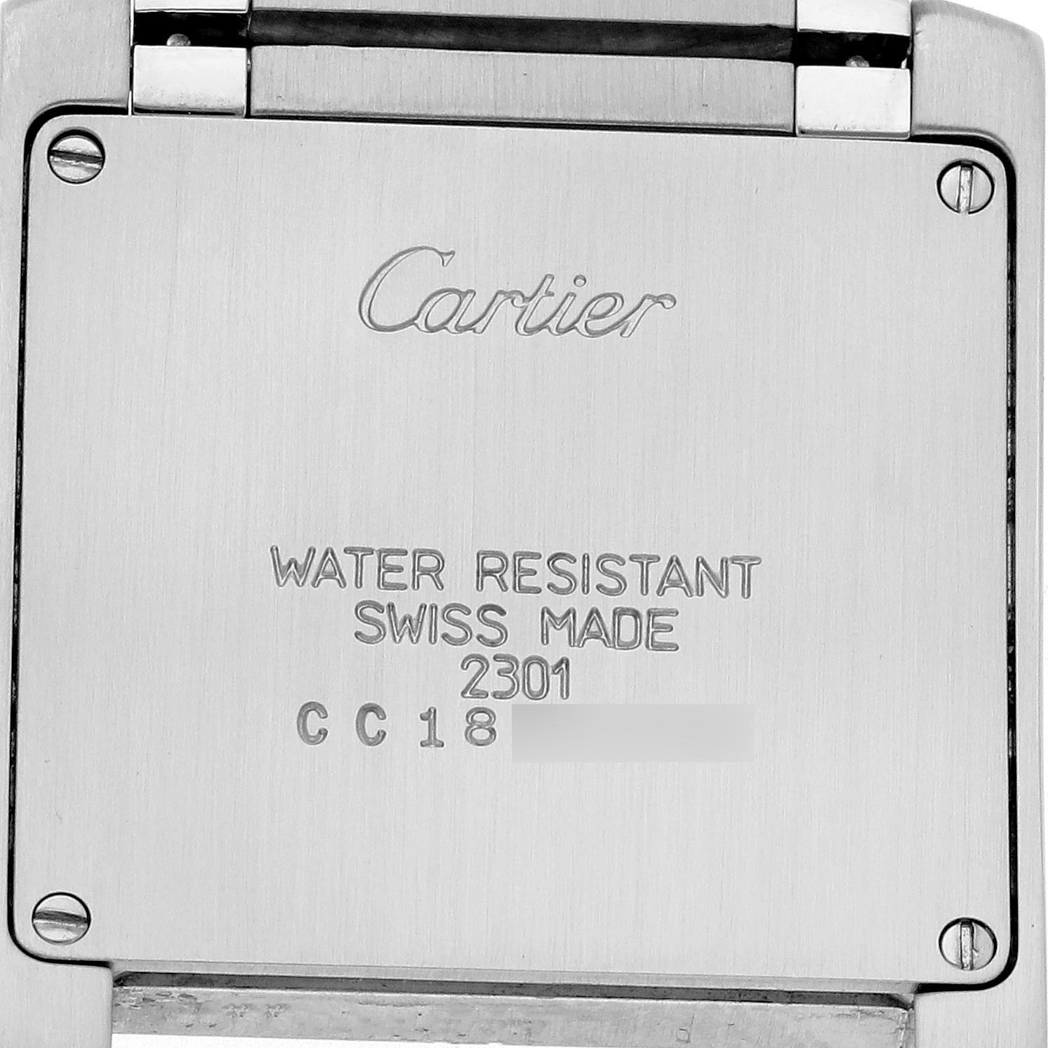 The image shows the back of a Cartier Tank Française watch, displaying its engraved details.