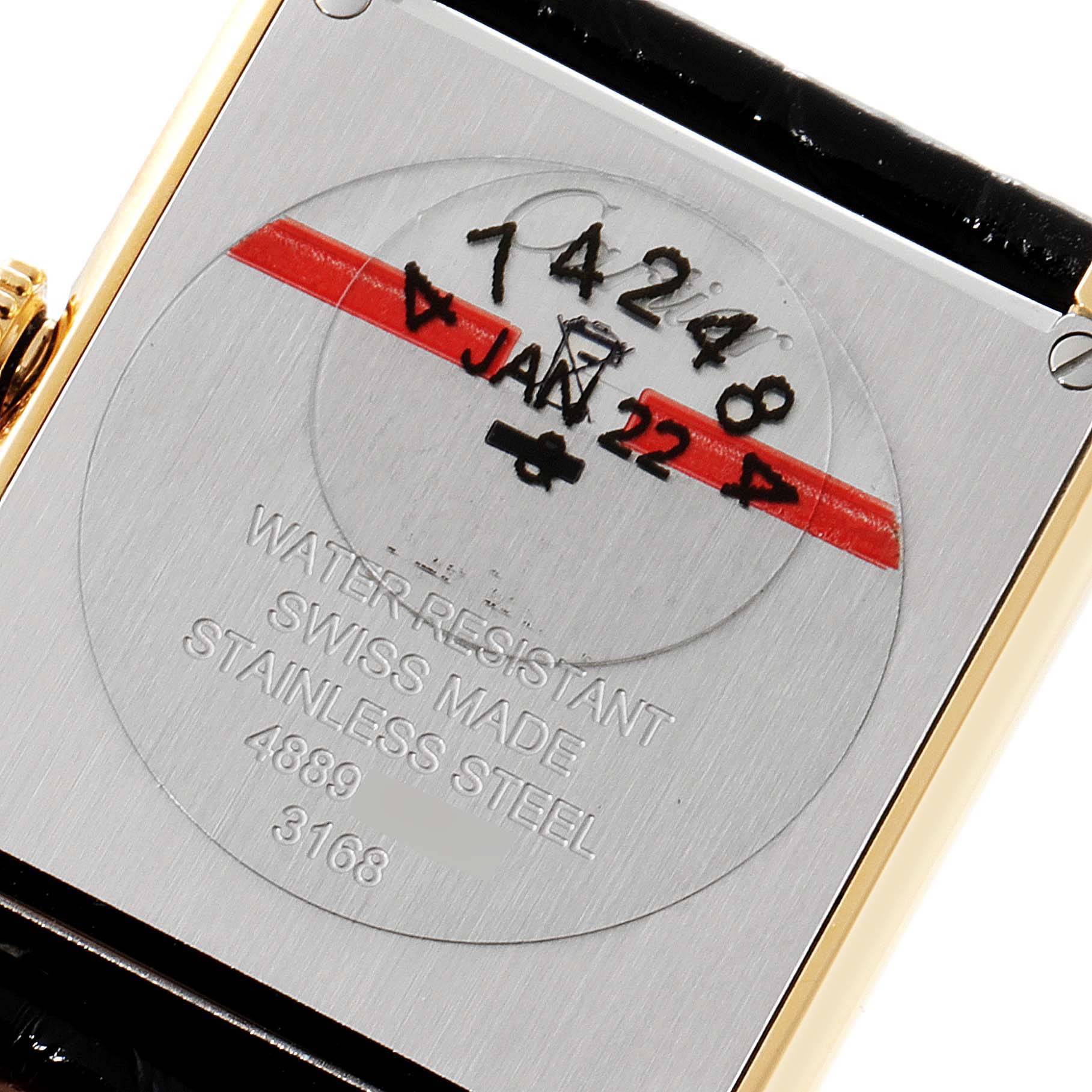 This image shows the back of a Cartier Tank Solo W5200002 Women's Yellow Gold Silver Dial W5200002 Women's Yellow Gold Silver Dial watch, highlighting its water resistance, "Swiss Made," and stainless steel properties.