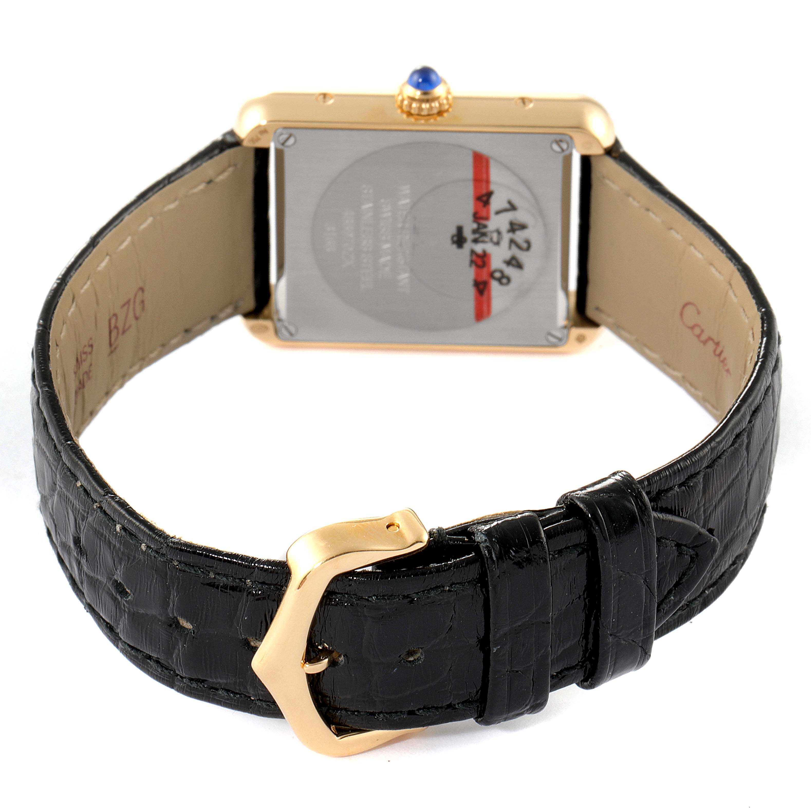 The image shows the back of a Cartier Tank Solo W5200002 Women's Yellow Gold Silver Dial W5200002 Women's Yellow Gold Silver Dial watch, including its black leather strap and gold buckle.