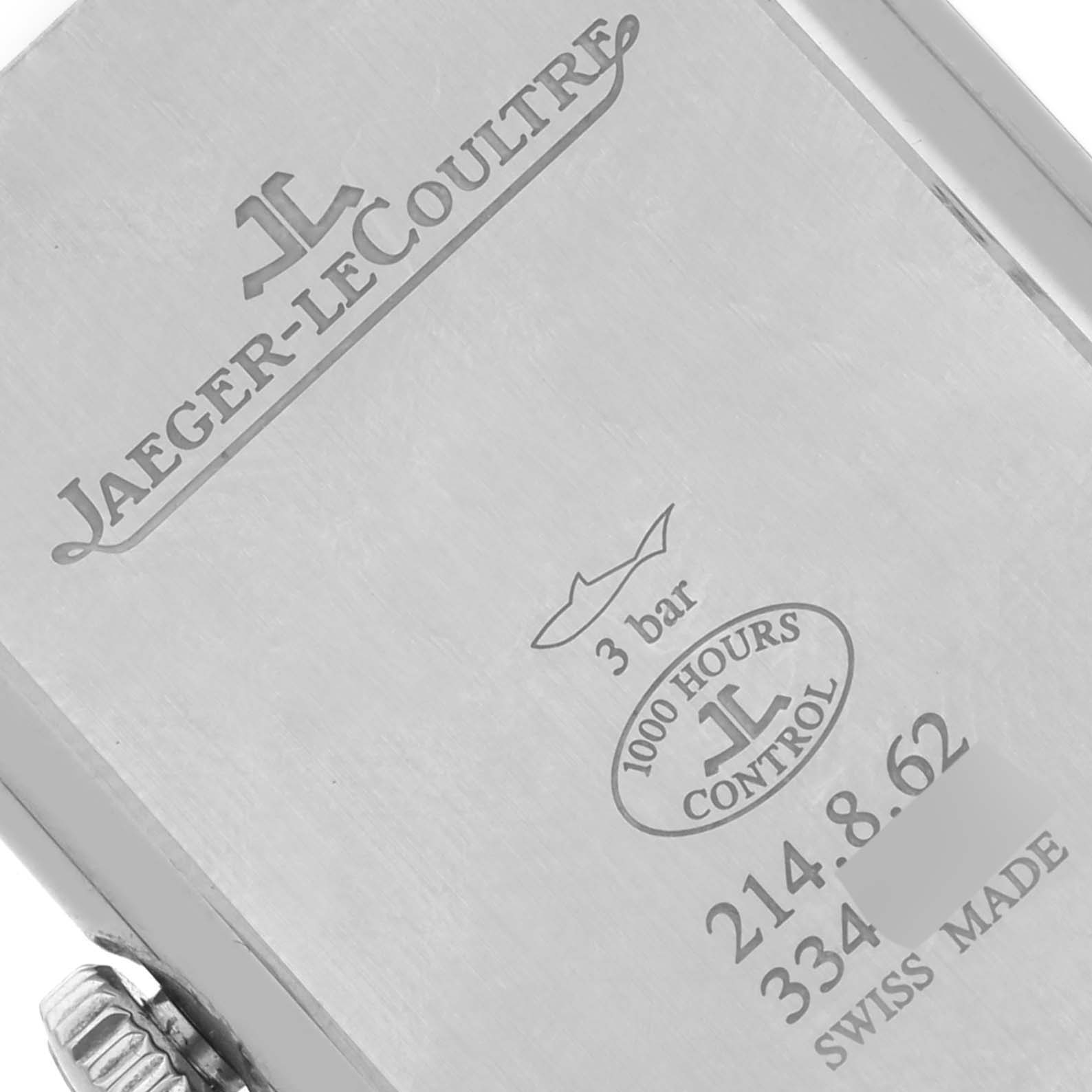 The image shows the back of a Jaeger-LeCoultre Reverso watch case with engravings and markings at an angled view.