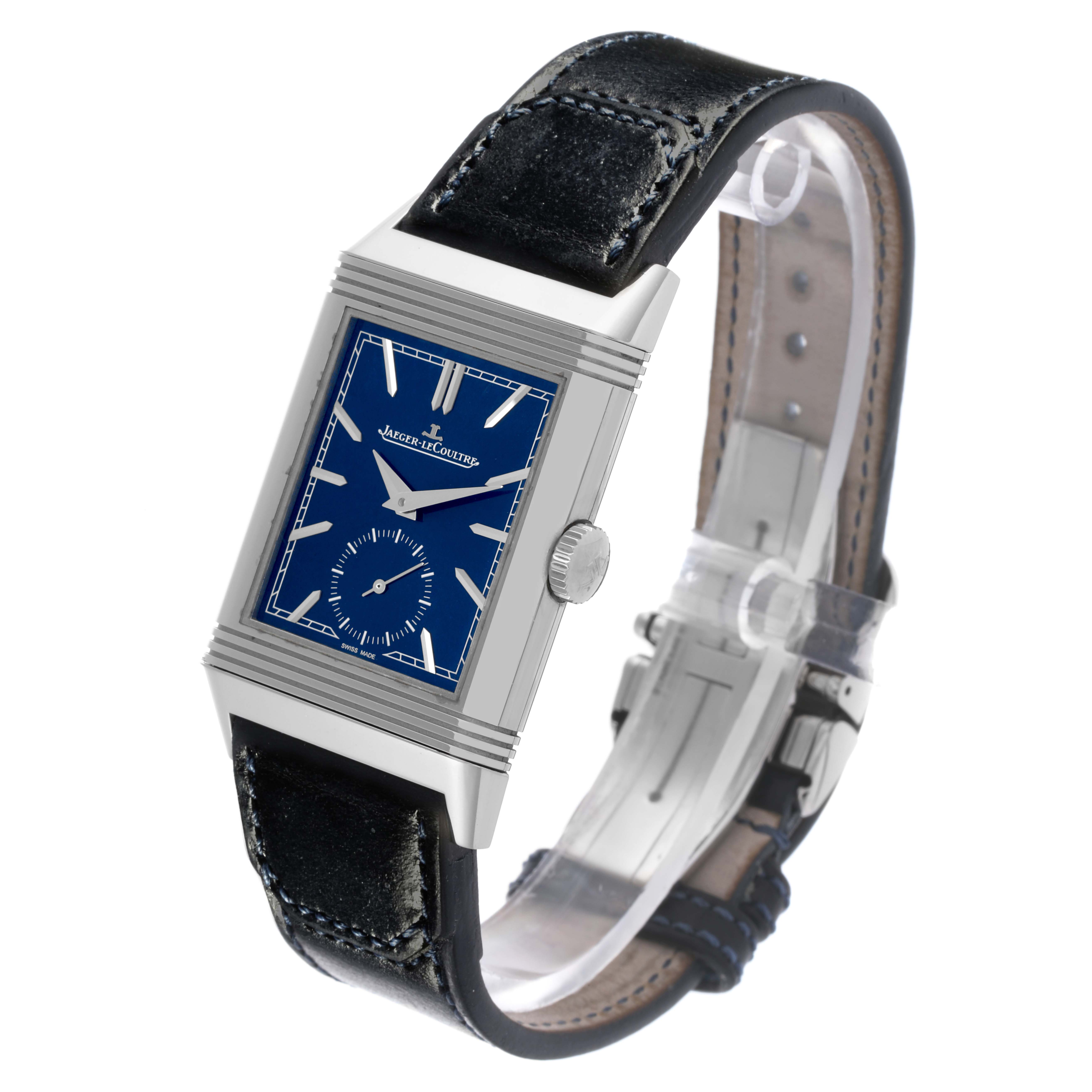 The Jaeger-LeCoultre Reverso watch is shown at an angle displaying its blue dial, rectangular case, crown, and leather strap.