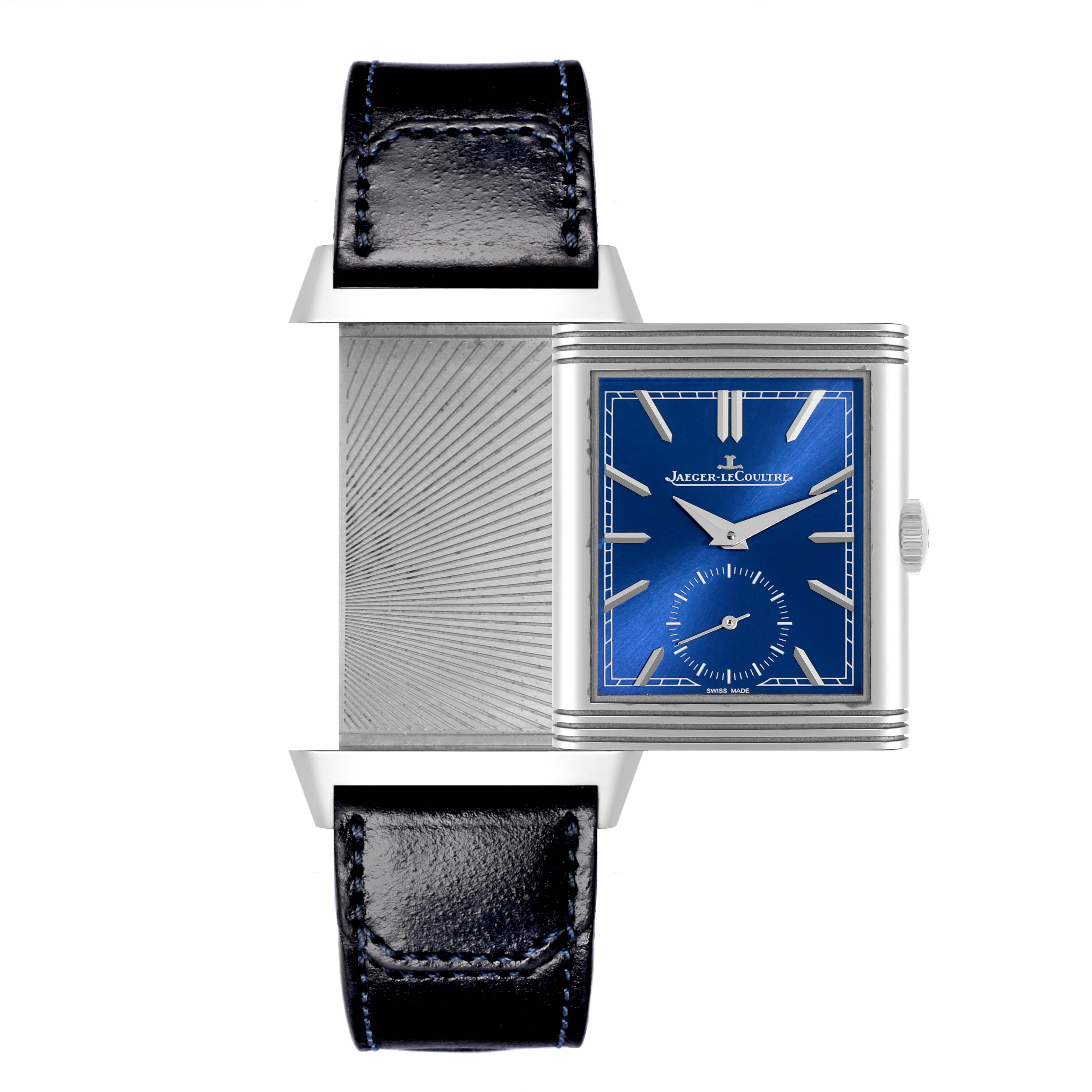 The Jaeger-LeCoultre Reverso watch is shown at a front angle with its case partially rotated, displaying both the blue dial and the decorative back.