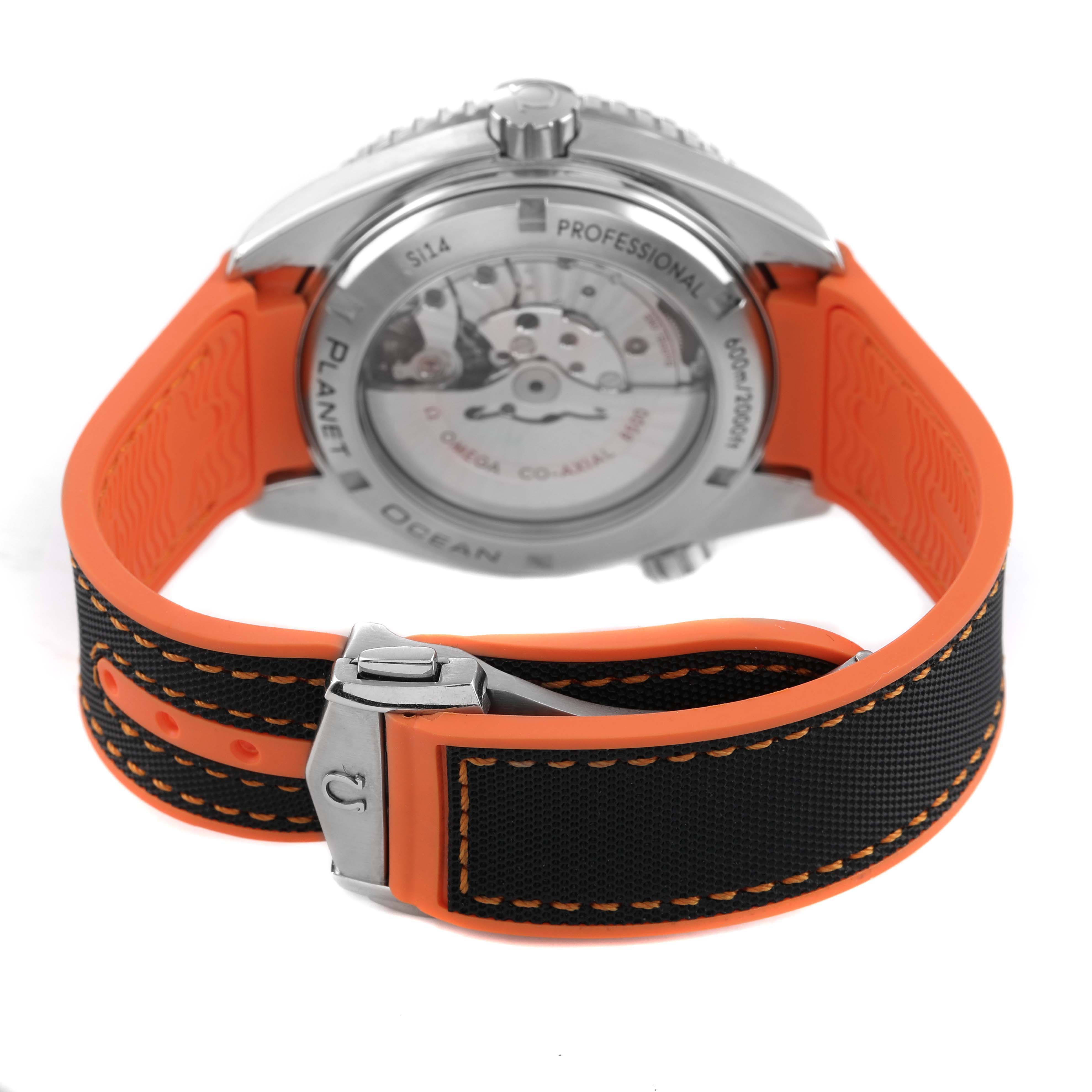 The Omega Planet Ocean 232.30.46.21.01.002 Men's Stainless Steel Black Dial watch is shown from the rear, displaying the open case back and orange strap.