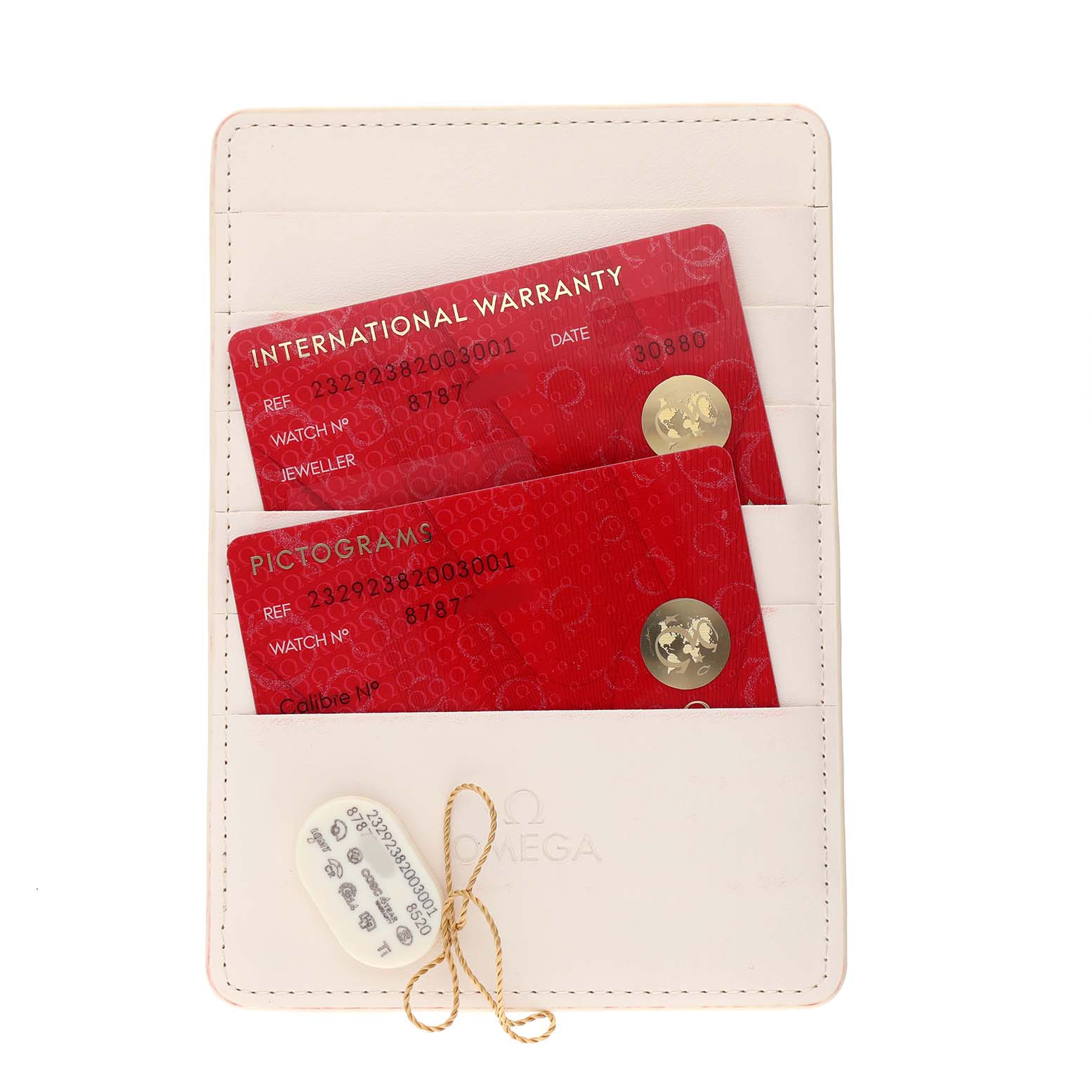 The image shows Omega Planet Ocean 232.92.38.20.03.001 Men's Titanium Blue Dial model's warranty cards in a holder, viewed from a top-down angle.