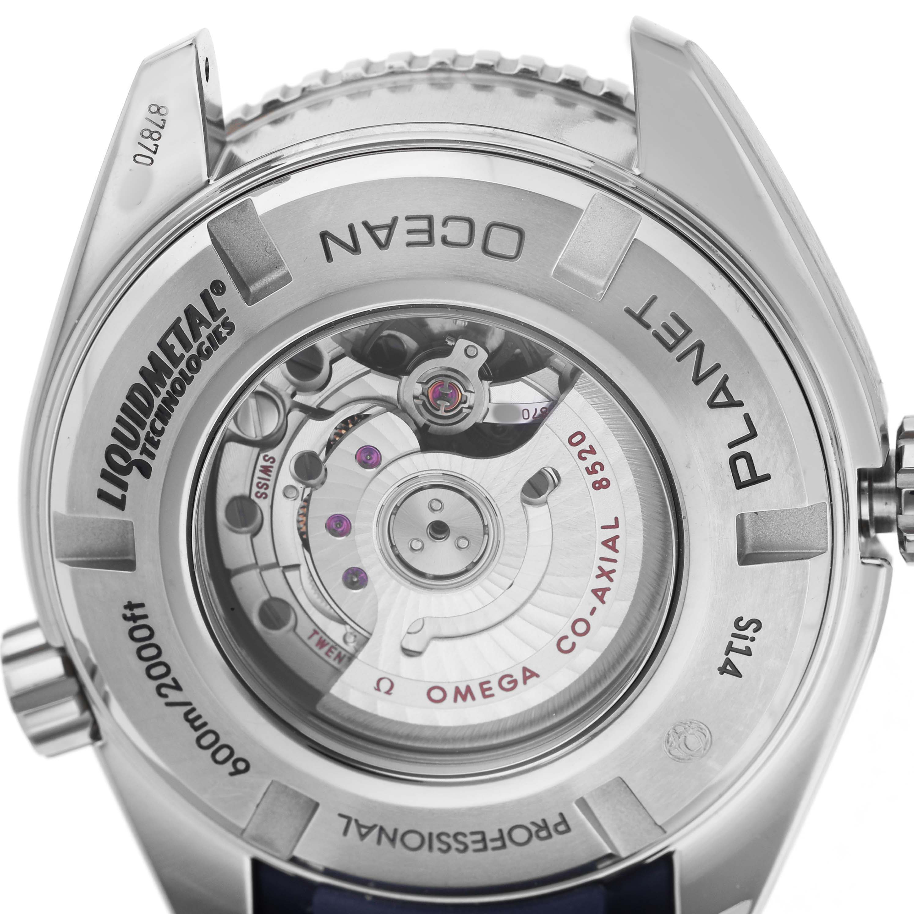 The image shows the case back of an Omega Planet Ocean 232.92.38.20.03.001 Men's Titanium Blue Dial watch, highlighting its mechanical movement and inscriptions.