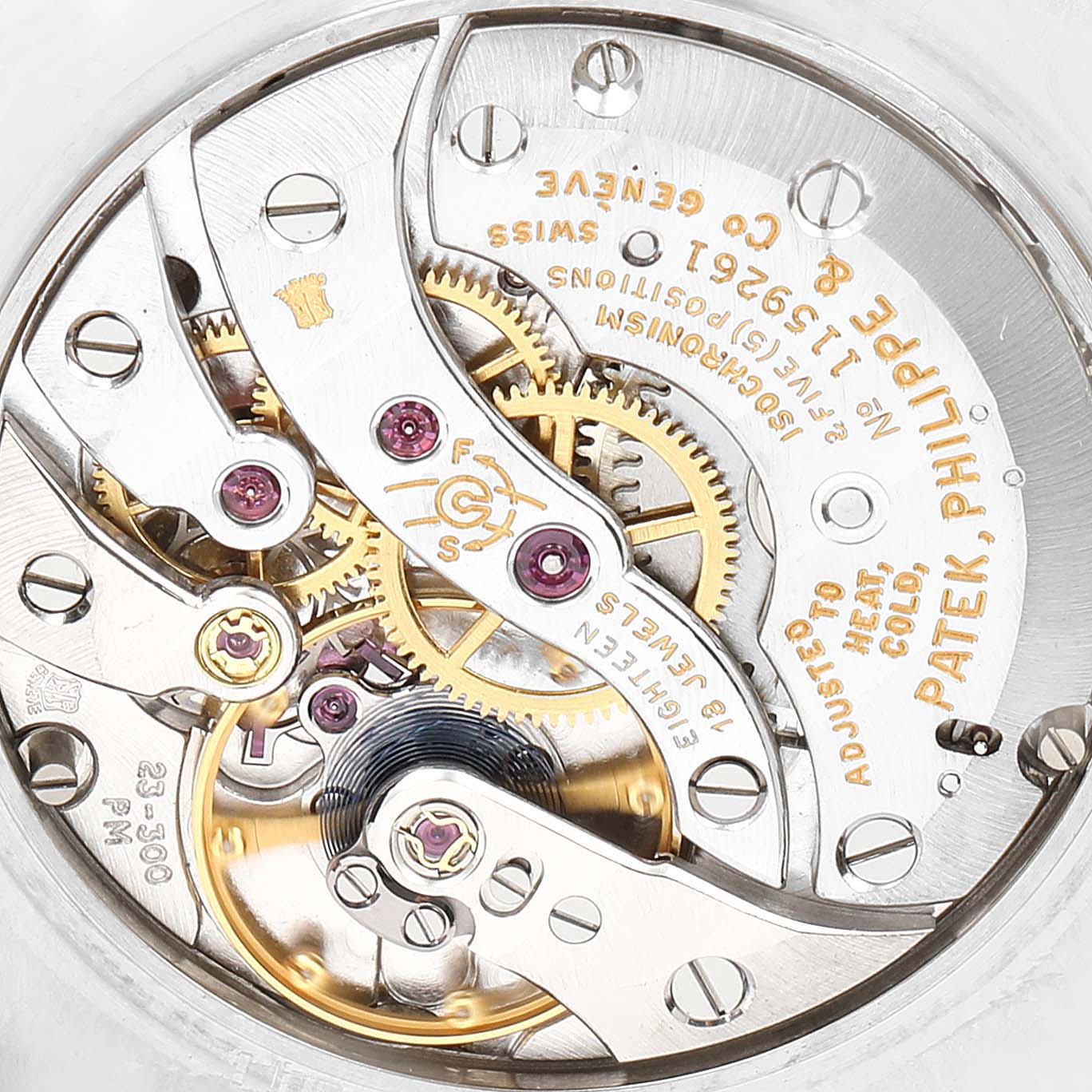 The image shows the intricate movement of a vintage Patek Philippe watch, viewed from the back.