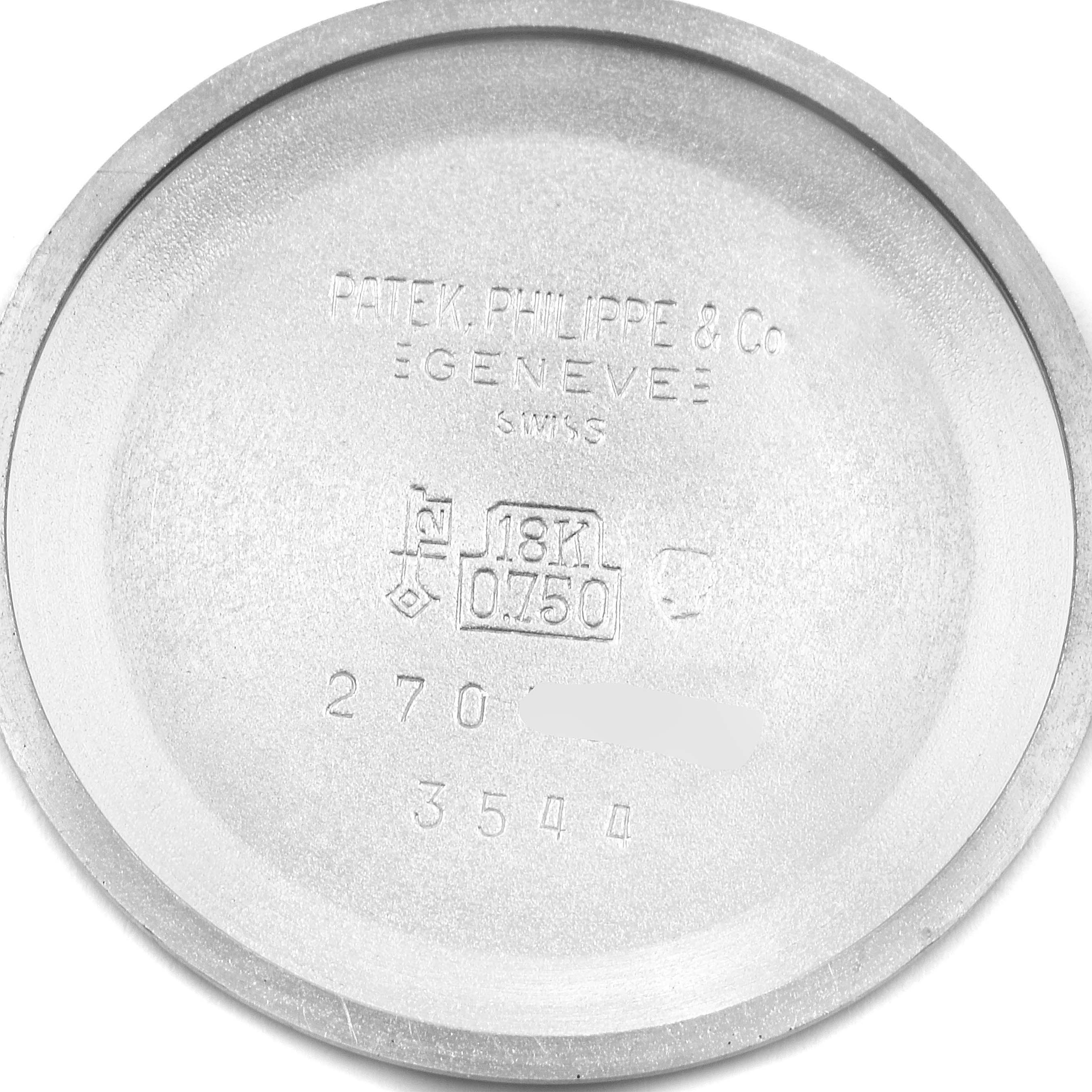 This image shows the inner case back of a Vintage Patek Philippe watch, highlighting the brand, model details, and hallmarks.