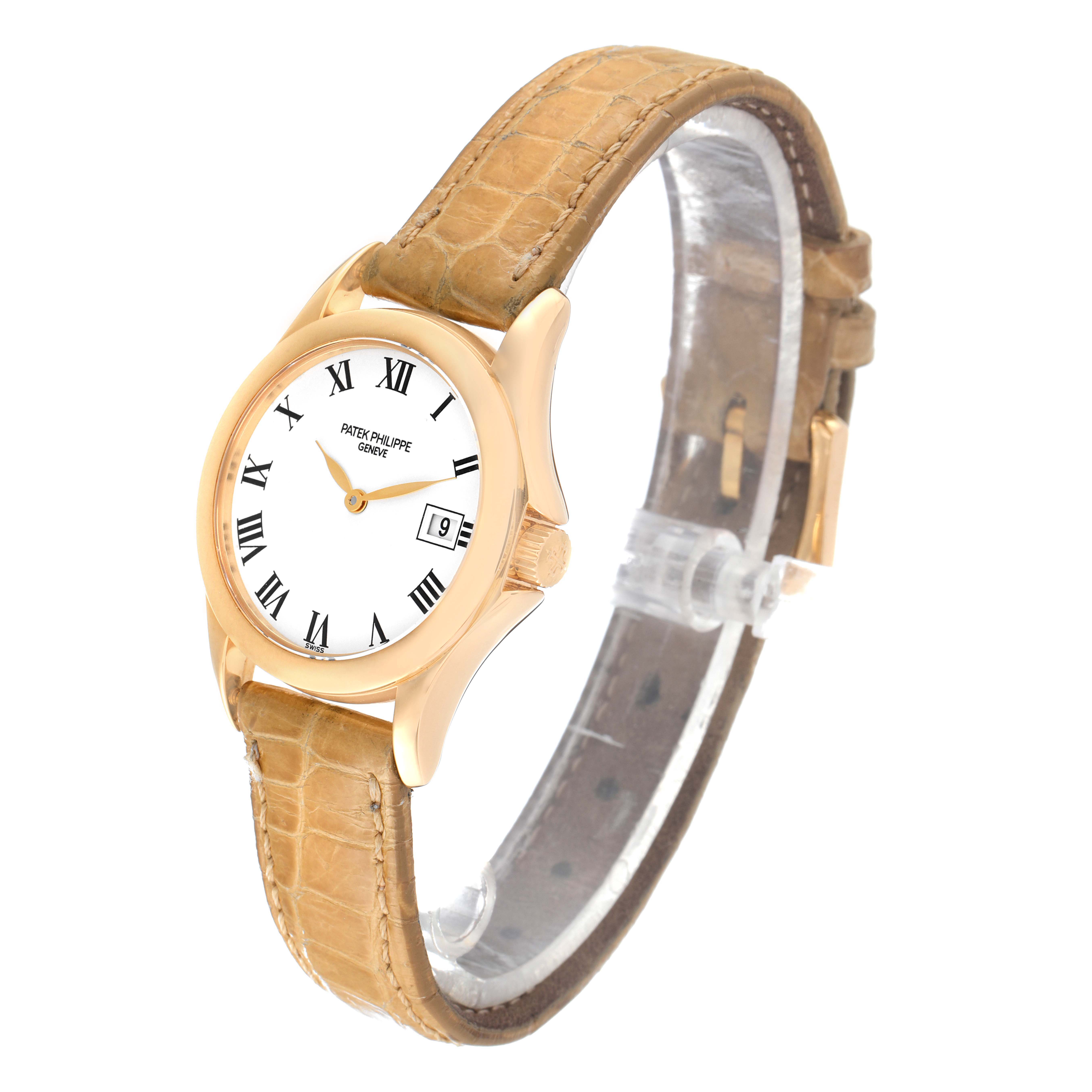 This image shows a Patek Philippe Calatrava 4906J-001 Women's Yellow Gold White Dial 4906J-001 Women's Yellow Gold White Dial watch angled leftwards, displaying its dial, case, and leather strap.