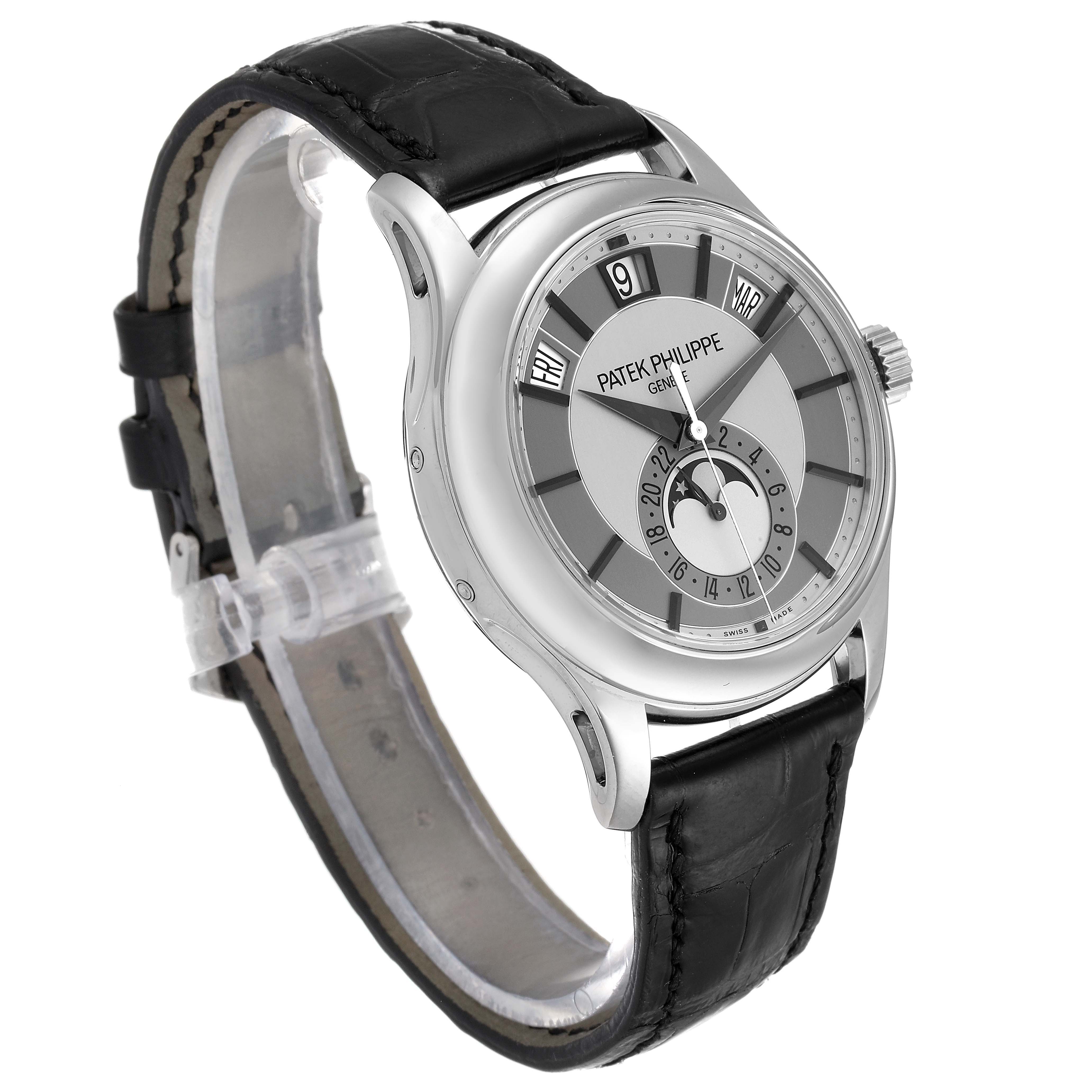 This image shows a Patek Philippe Complications 5205G  Men's White Gold Silver Dial 5205G  Men's White Gold Silver Dial model watch from an angled side view, revealing the dial, case, and leather strap.