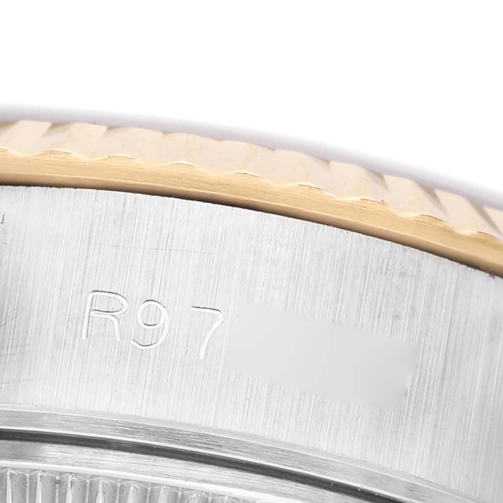 The image shows a close-up of the side of a Rolex Datejust 69173 Women's Stainless Steel Champagne Dial, focusing on the case with engraved text and the fluted bezel.