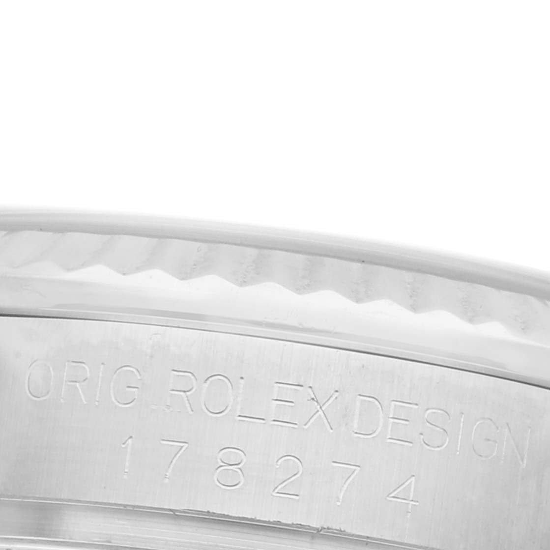 The image shows a close-up side view of the engraved bezel and case of a Rolex Mid-Size 178274 Women's Stainless Steel Silver Dial 178274 Women's Stainless Steel Silver Dial model.