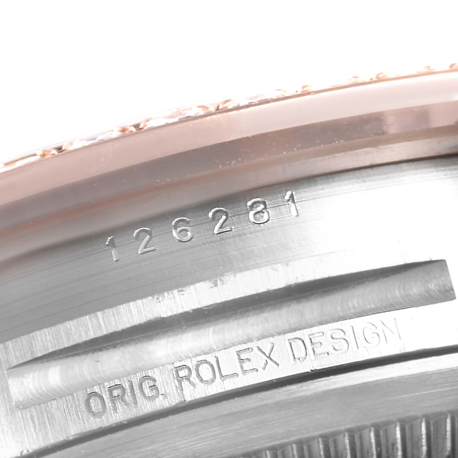 The image shows a close-up of the serial number and "ORIG ROLEX DESIGN" engraving on the case of the Rolex Datejust 126281 Men
s Steel and Gold (two tone) Grey Dial 126281 Men
s Steel and Gold (two tone) Grey Dial watch.