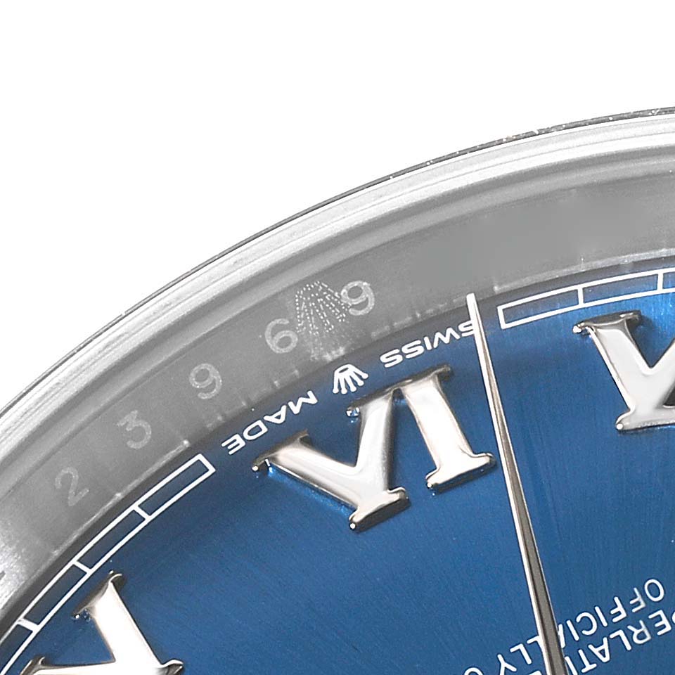 The image shows a close-up of the Rolex Datejust 41 126300 Men
s Stainless Steel Blue Dial 126300 Men
s Stainless Steel Blue Dial watch
s blue dial, featuring the Roman numerals and part of the chapter ring.